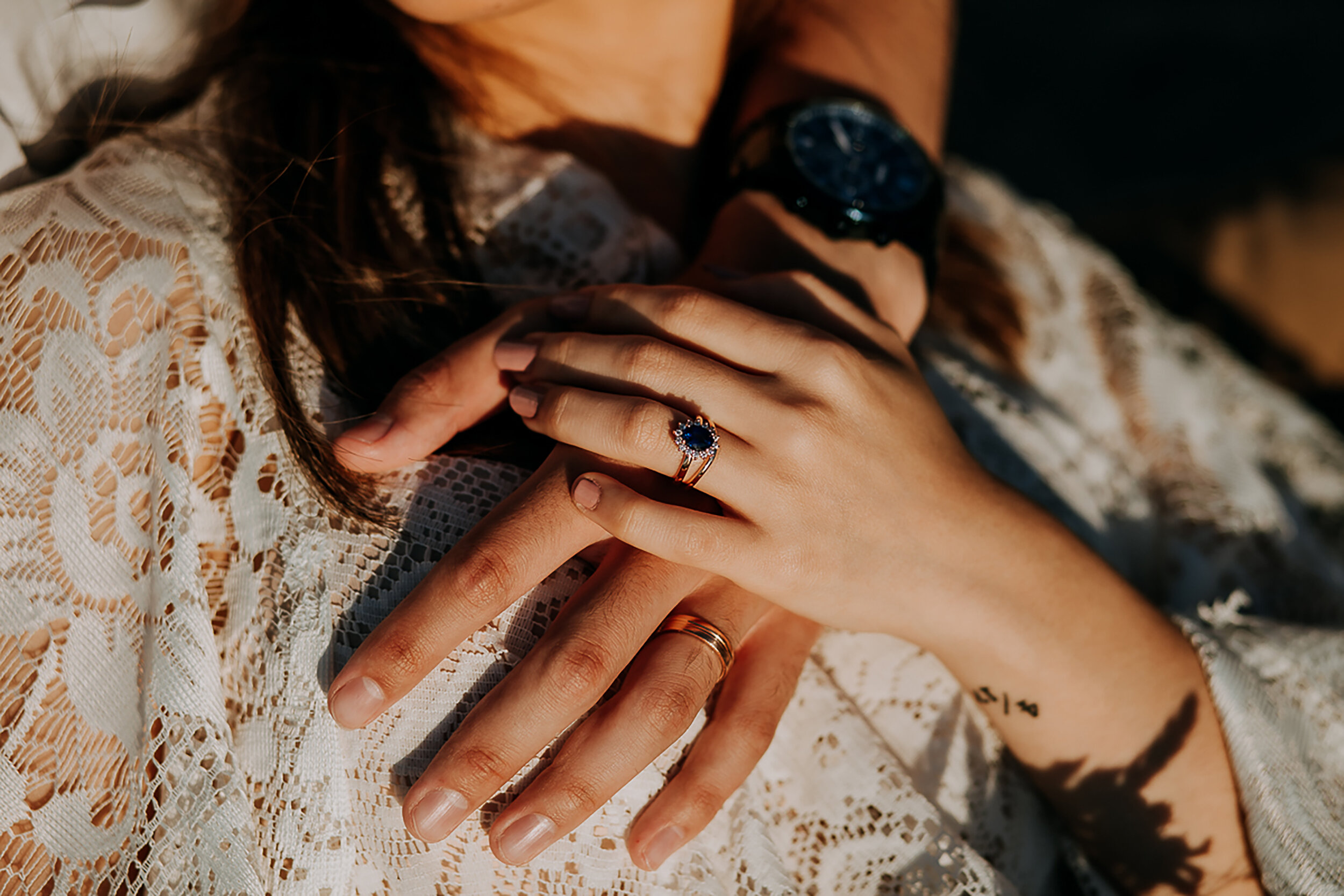  Kindred &amp; Co. Photography captures wedding day details for this bohemian elopement in Ogden Dunes Indiana. 2ct blue diamond wedding ring, yellow gold womens wedding band, nude wedding nail color, black mens wedding watch, bride and groom hugging