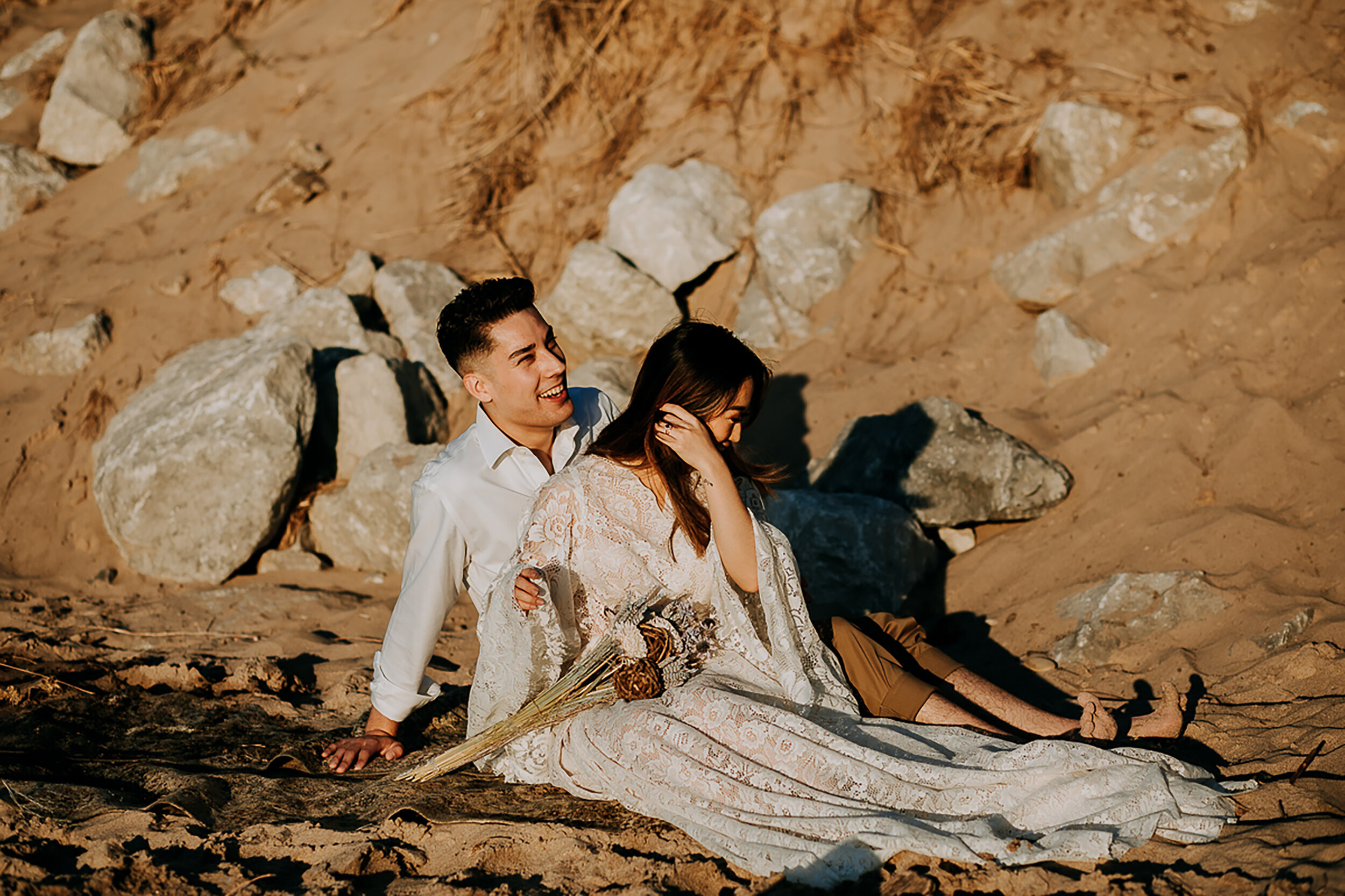  Blissfully candid wedding moments captured by Kindred &amp; Co. Photography in Indiana Dunes State Park. 2ct blue diamond wedding ring, loose fitted lace bohemian elopement wedding dress, bride and groom sitting and laughing elopement picnic, profes
