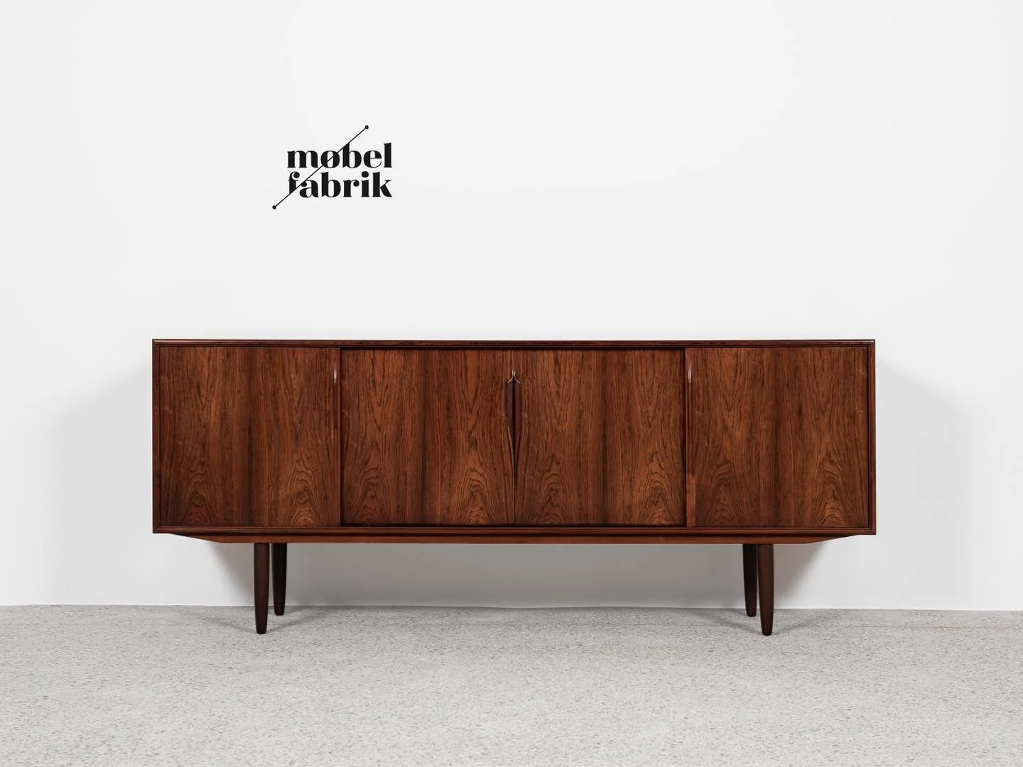 Midcentury Danish sideboard in rosewood by Axel Christensen for ACO M&oslash;bler 1960s

This sideboard is designed by Axel Christensen and manufactured by ACO M&oslash;bler in Denmark in the 1960s. This model is often attributed to Gunni Omann, but 