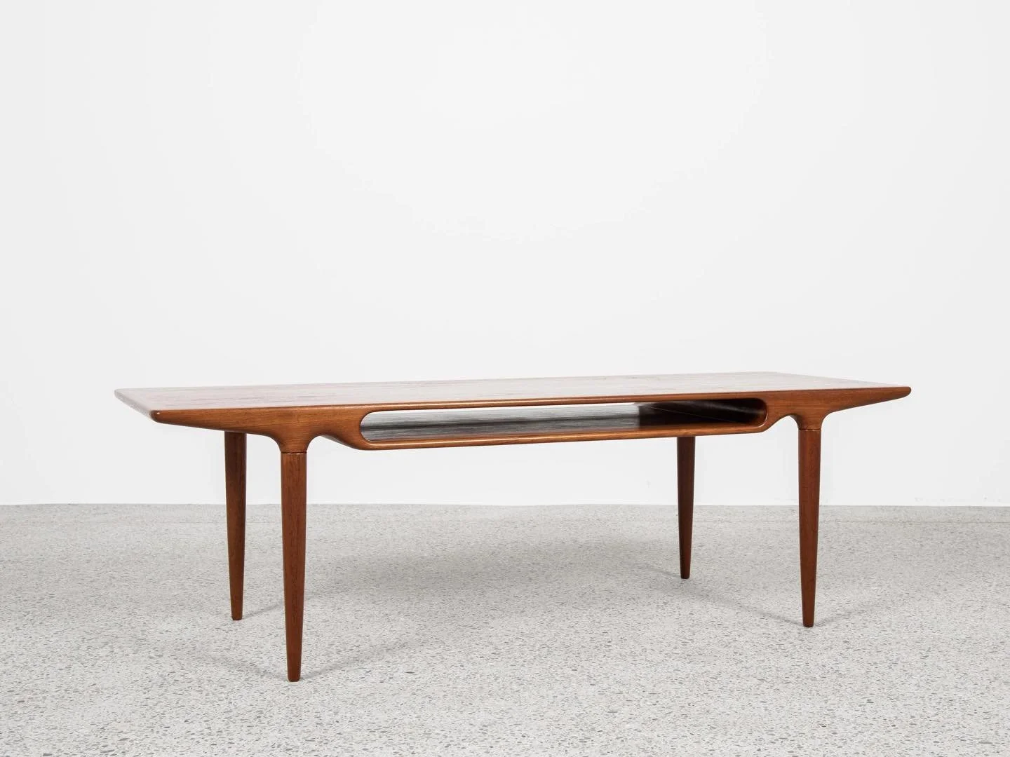 Midcentury Danish rectangular coffee table in teak by Johannes Andersen for Silkeborg 1960s

This coffee table is designed by Johannes Andersen and manufactured by CFC Silkeborg in Denmark in the 1960s. This is a very beautiful design - refined in ev