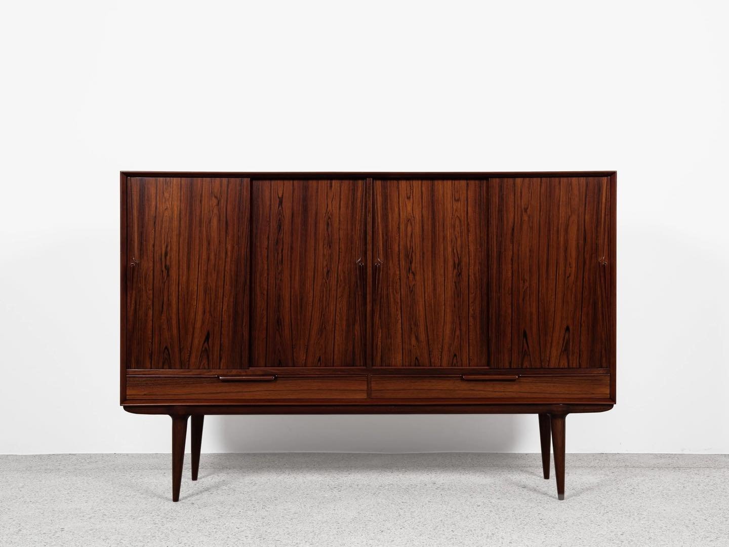 Midcentury Danish highboard Model 13 in rosewood by Omann Jun 1960s

This beautiful highboard Model 13 is designed and manufactured by Omann Jun in Denmark in the 1960s. This piece of furniture is refined in every detail and shows top quality manufac