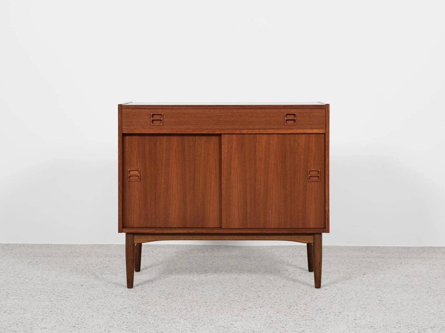 Midcentury Danish cabinet in teak with 1 drawer and 2 sliding doors 1960s

This cabinet is made in Denmark in the 1960s. There are beautiful drawings in the wood. The design of the door and drawer handles are typical. The cabinet has 1 drawer and 2 s