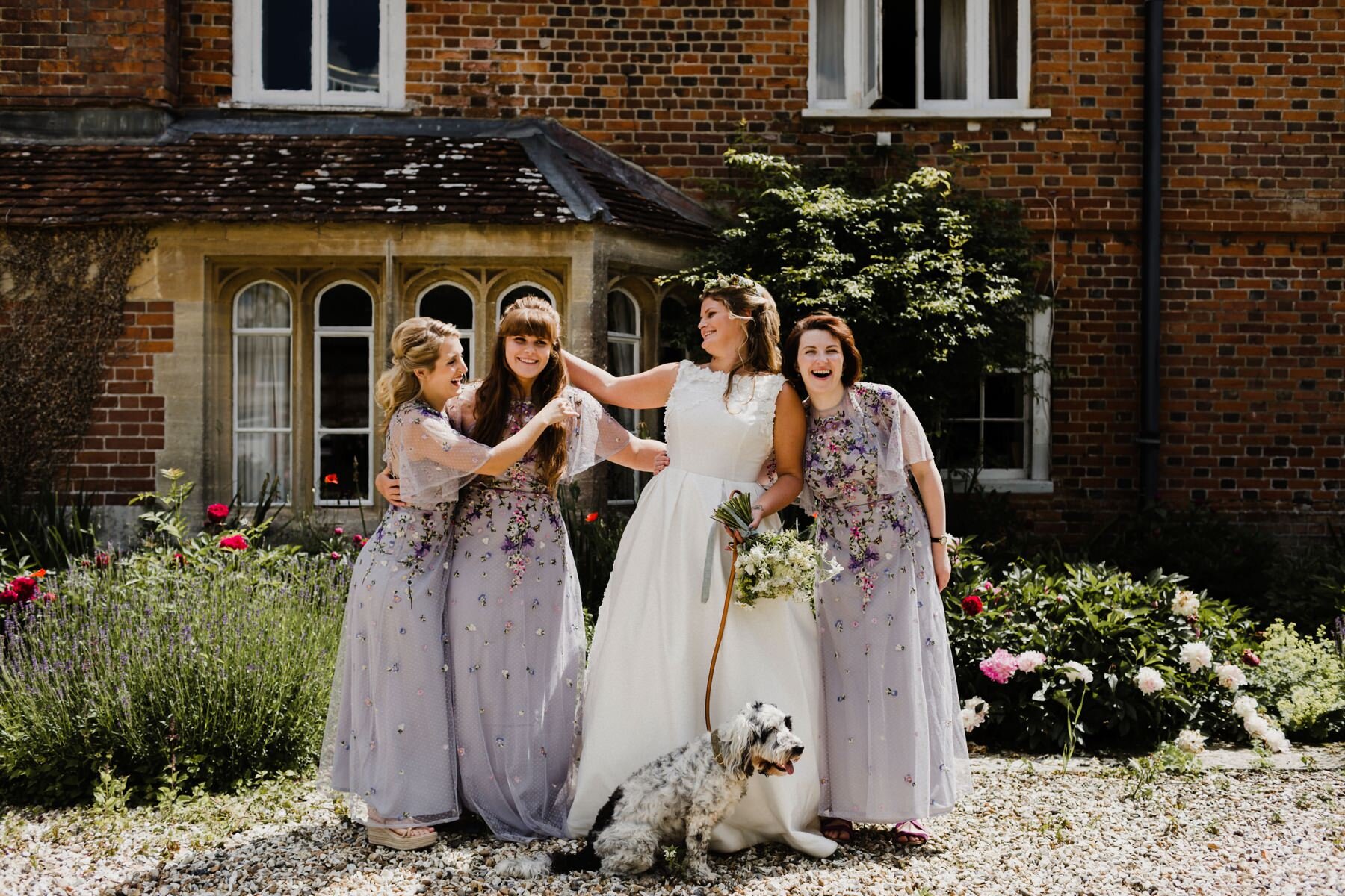 Bride and her bridesmaids laugh and joke before the wedding ceremony at Kingsettle Stud