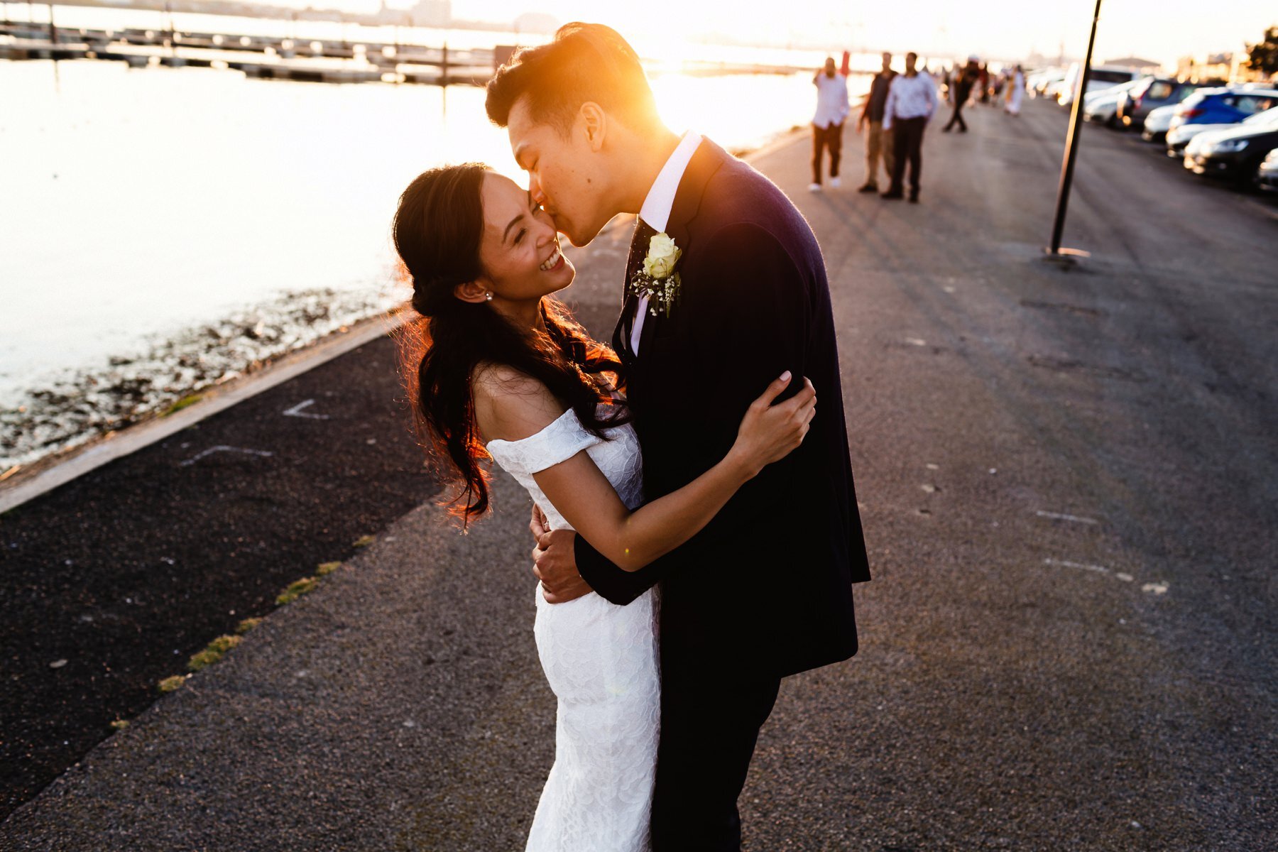 Wedding couple embrace on Southampton's waterfront after their wedding at the Dancing Man Brewery.