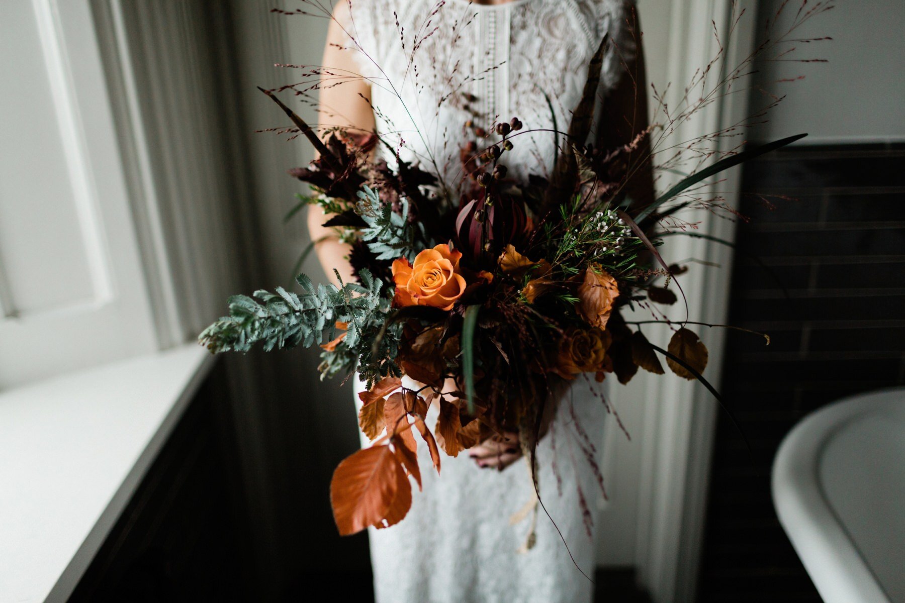 An autumnal, rustic wedding bouquet at Horsley Towers in Surrey.
