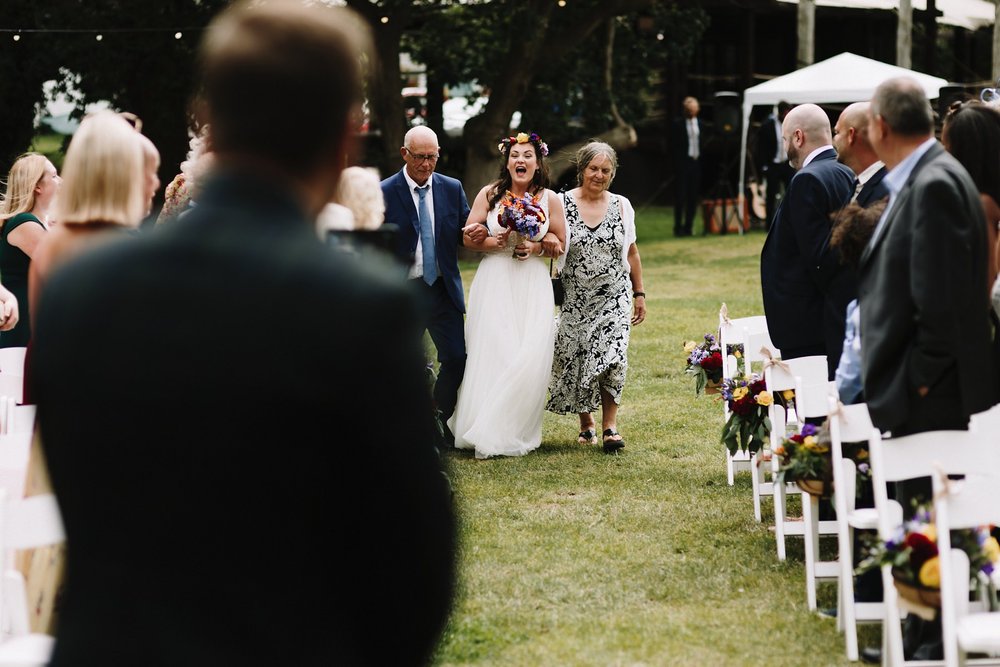 Bride walking down the aisle at Tournerbury Woods outdoors wedding venue