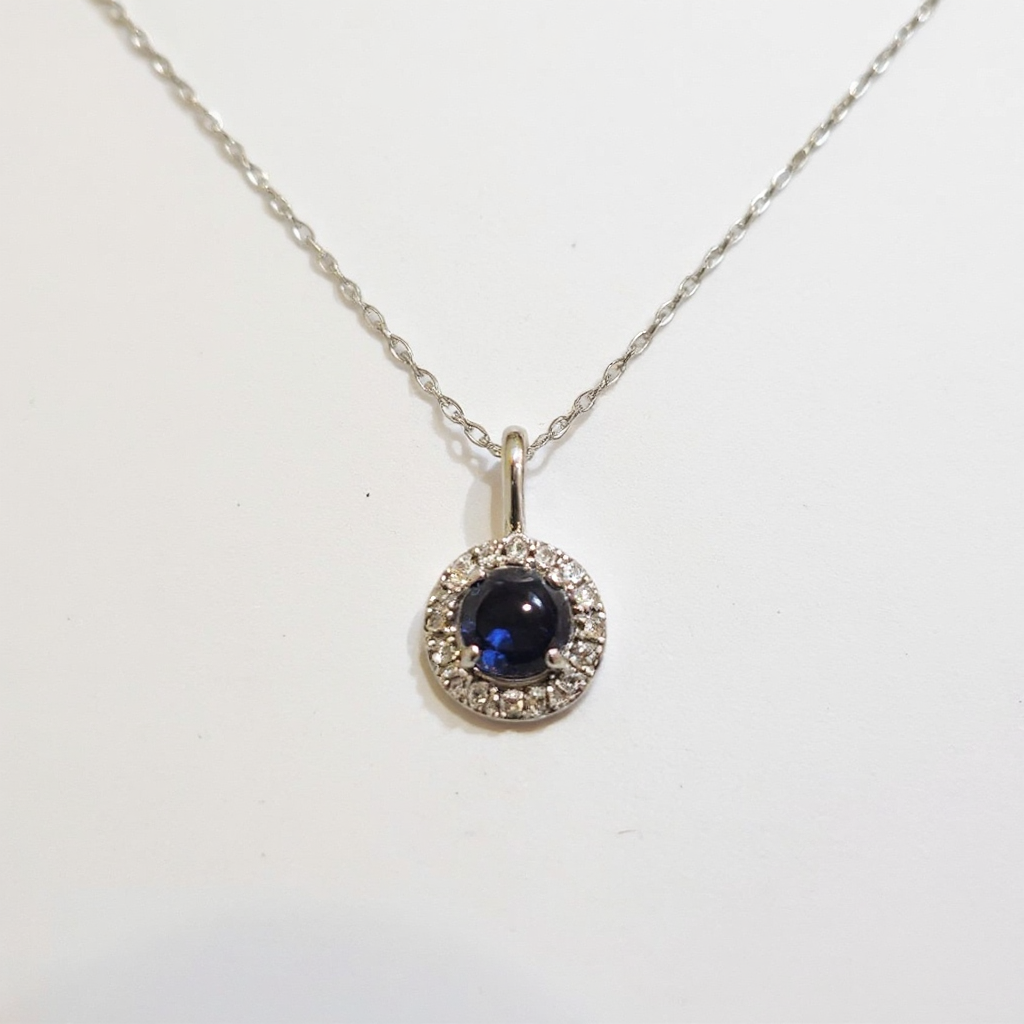 Make the silver necklace shinier, enhance the brilliance of the sapphire, and replace the background with a brighter one.png