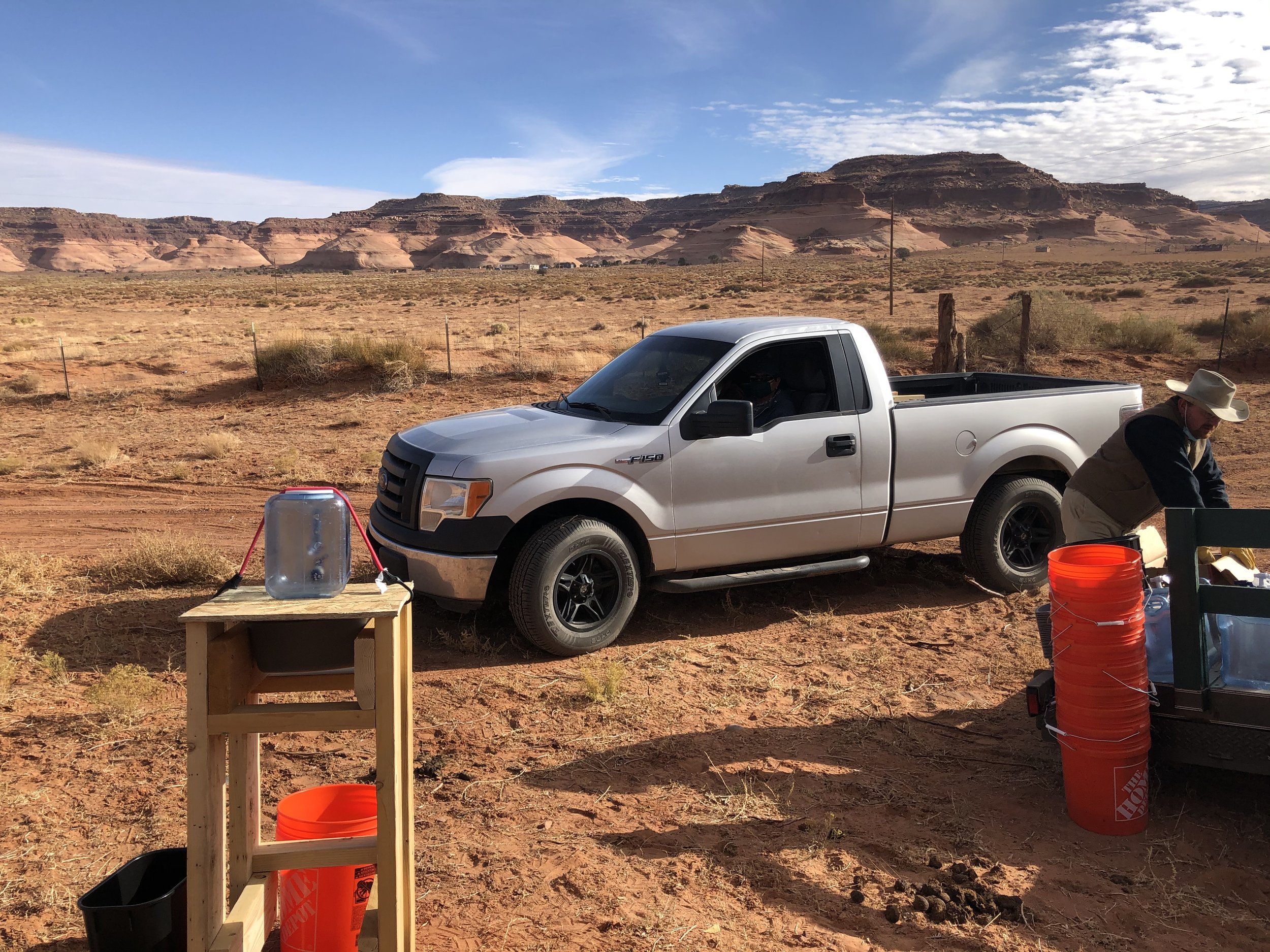 Handwashing station with truck and bluff in background.JPG