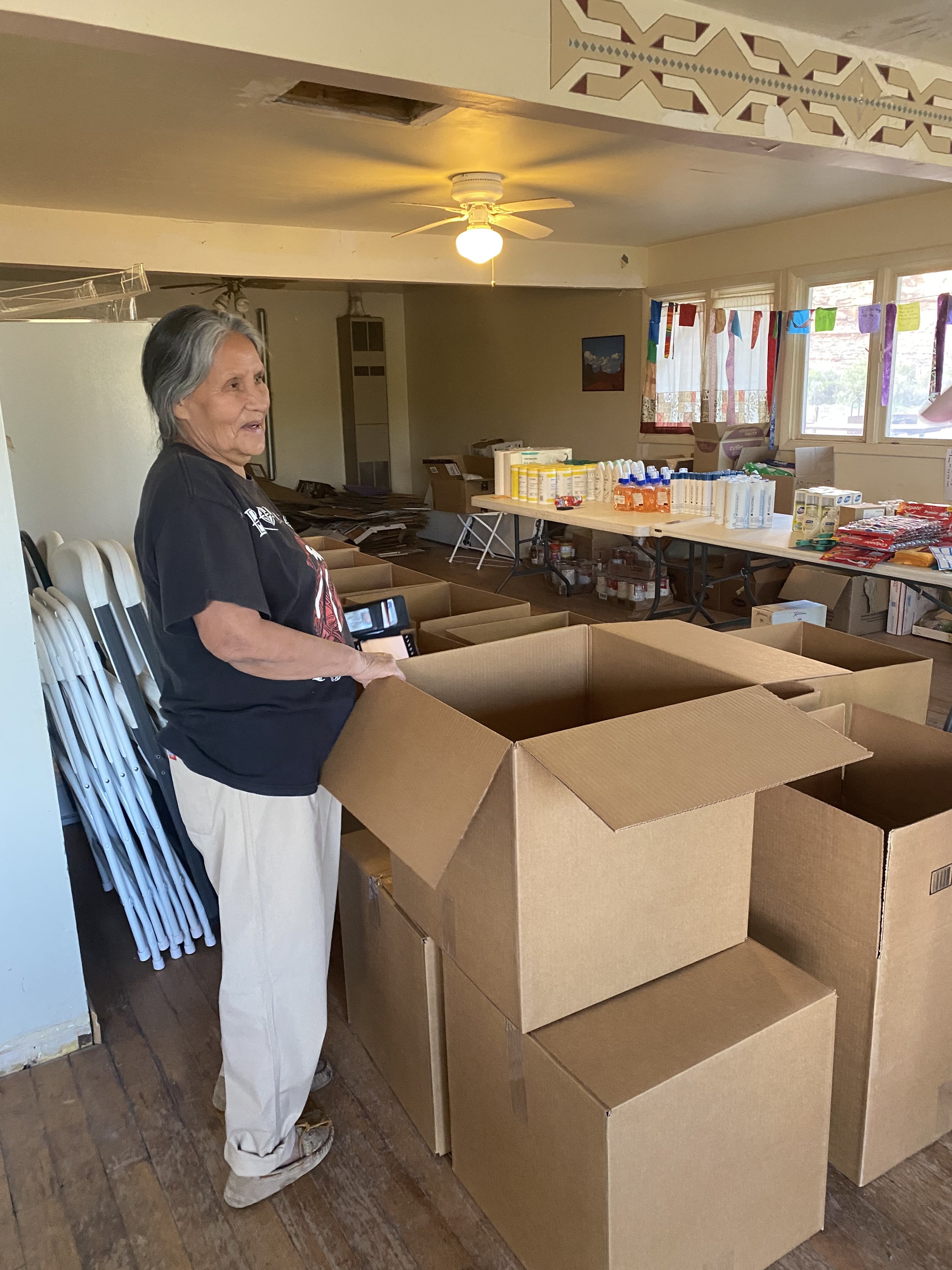 Local volunteer with care boxes.JPG