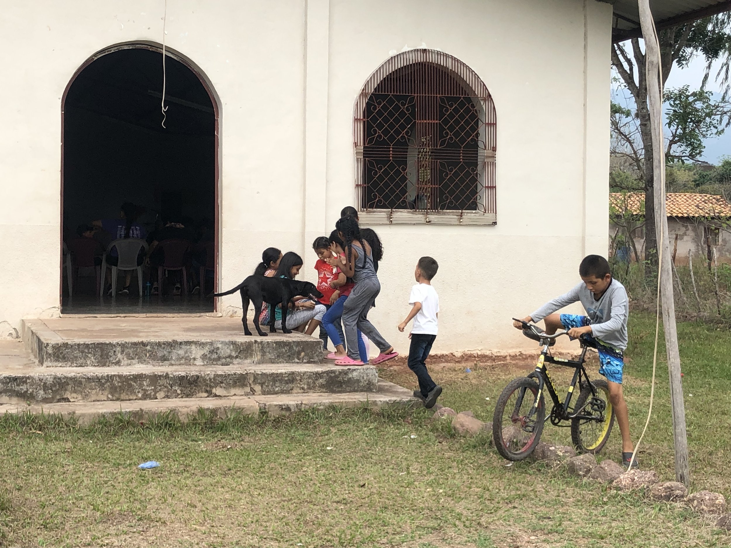 Children and dog outside Health & Hygiene worship QG.jpg