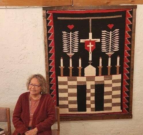 Mother Paula seated by weaving of cross.JPG