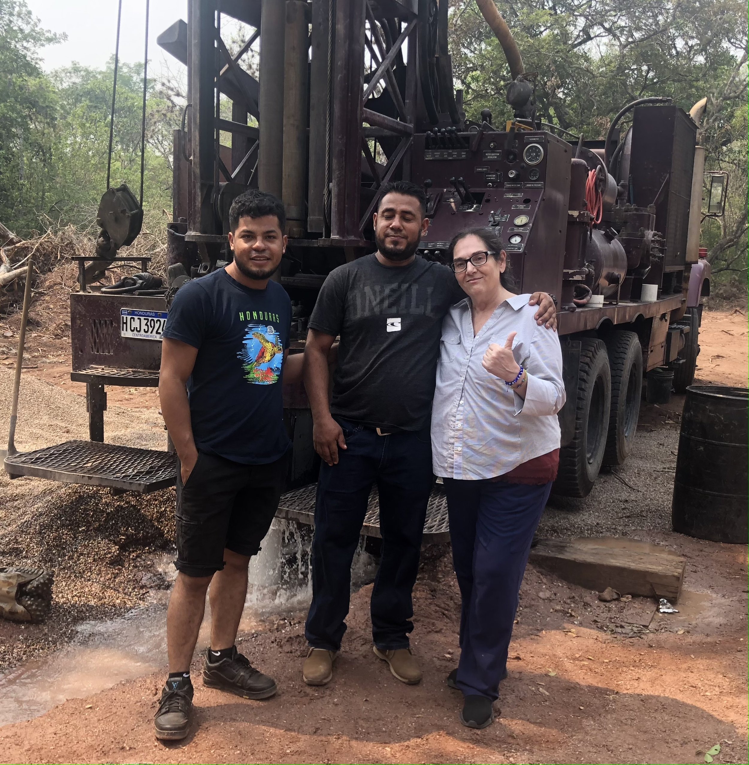 Luis Reyes, LF & Roxana in front of drill rig.jpg