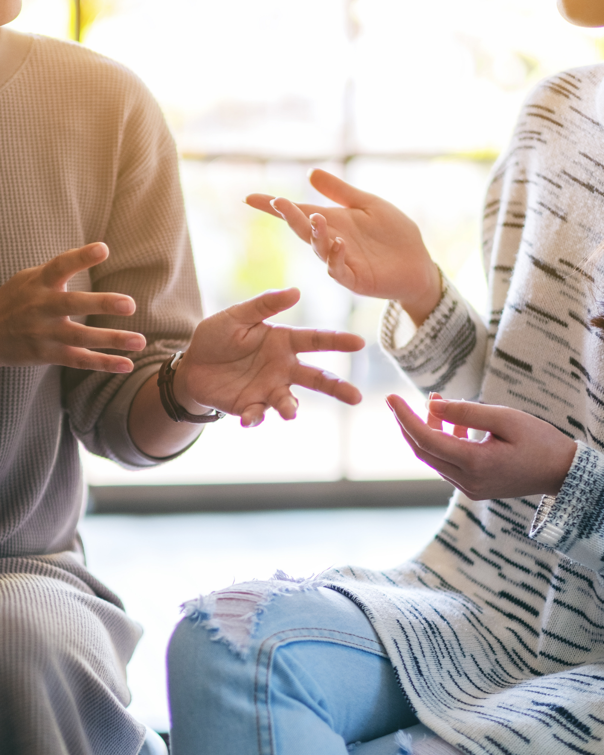 two sets of hands as people have a conversation