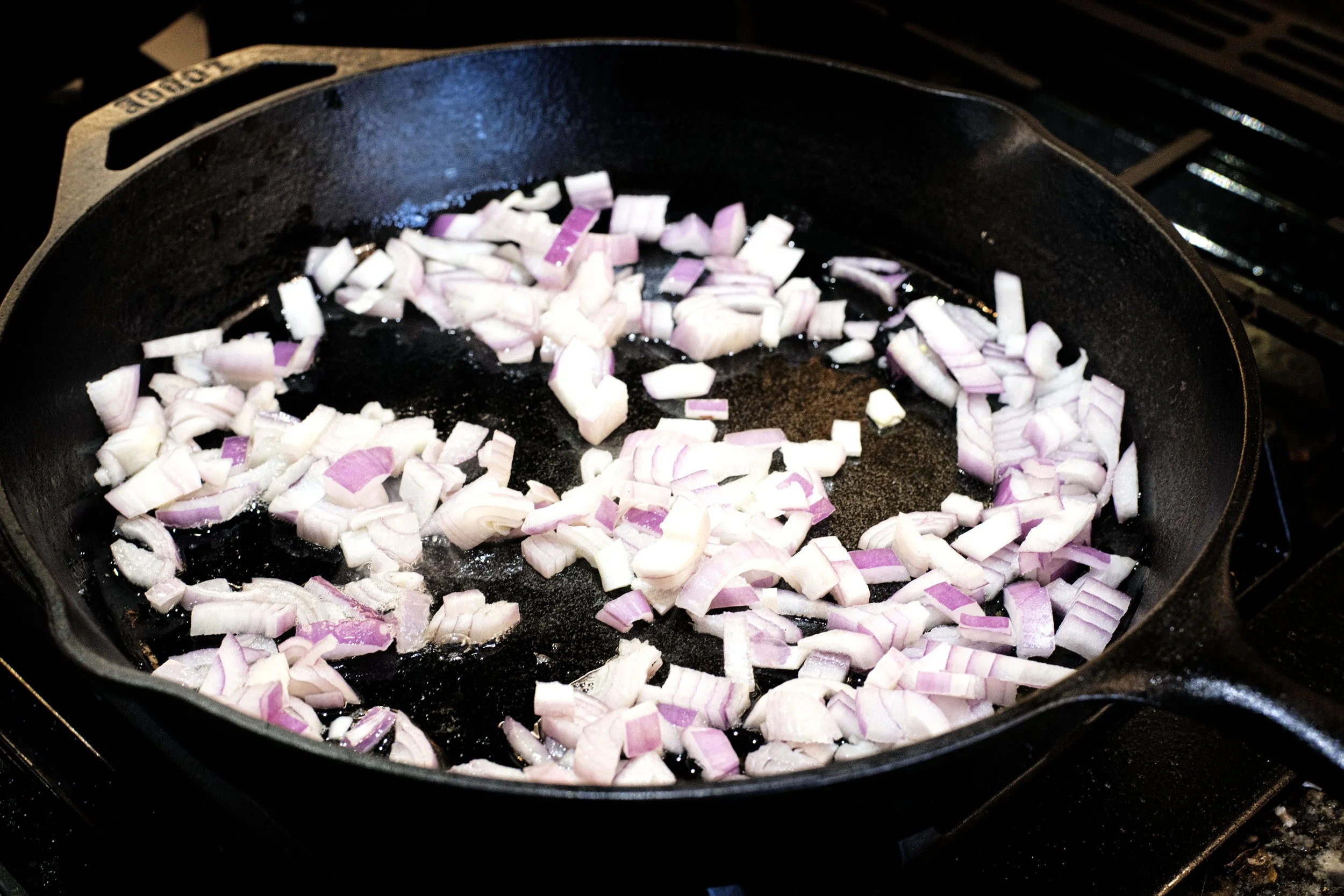 Red Onions cooking in a cast iron skillet