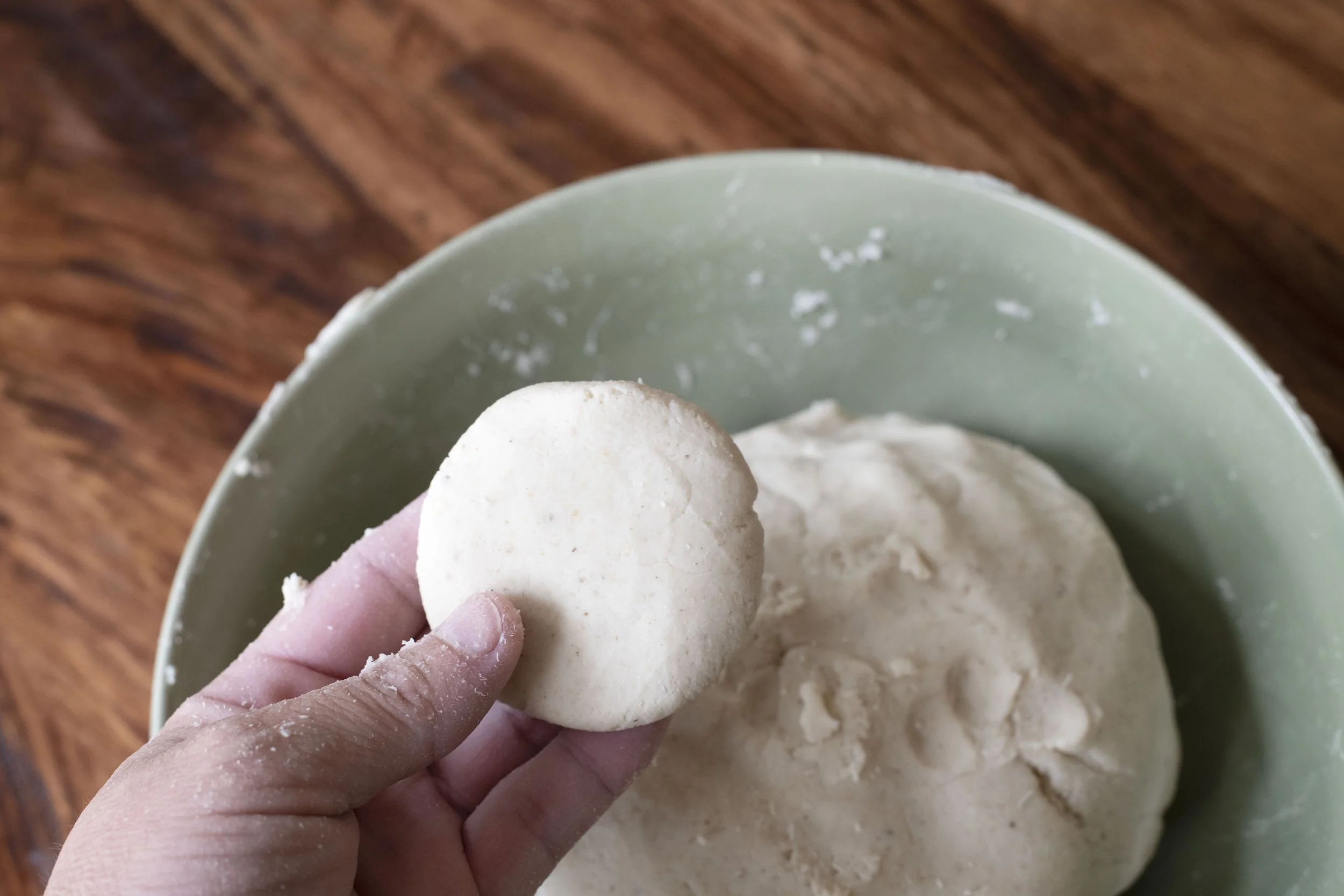 Mixed masa harina dough pressed into a flat disc
