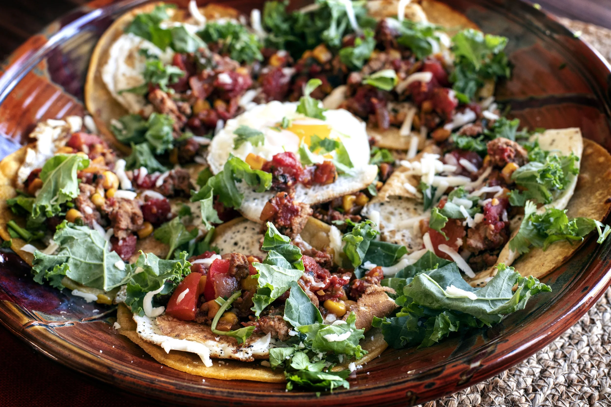 Pheasant Shakshuka tacos with green kale, roasted tomatoes, and a fried egg