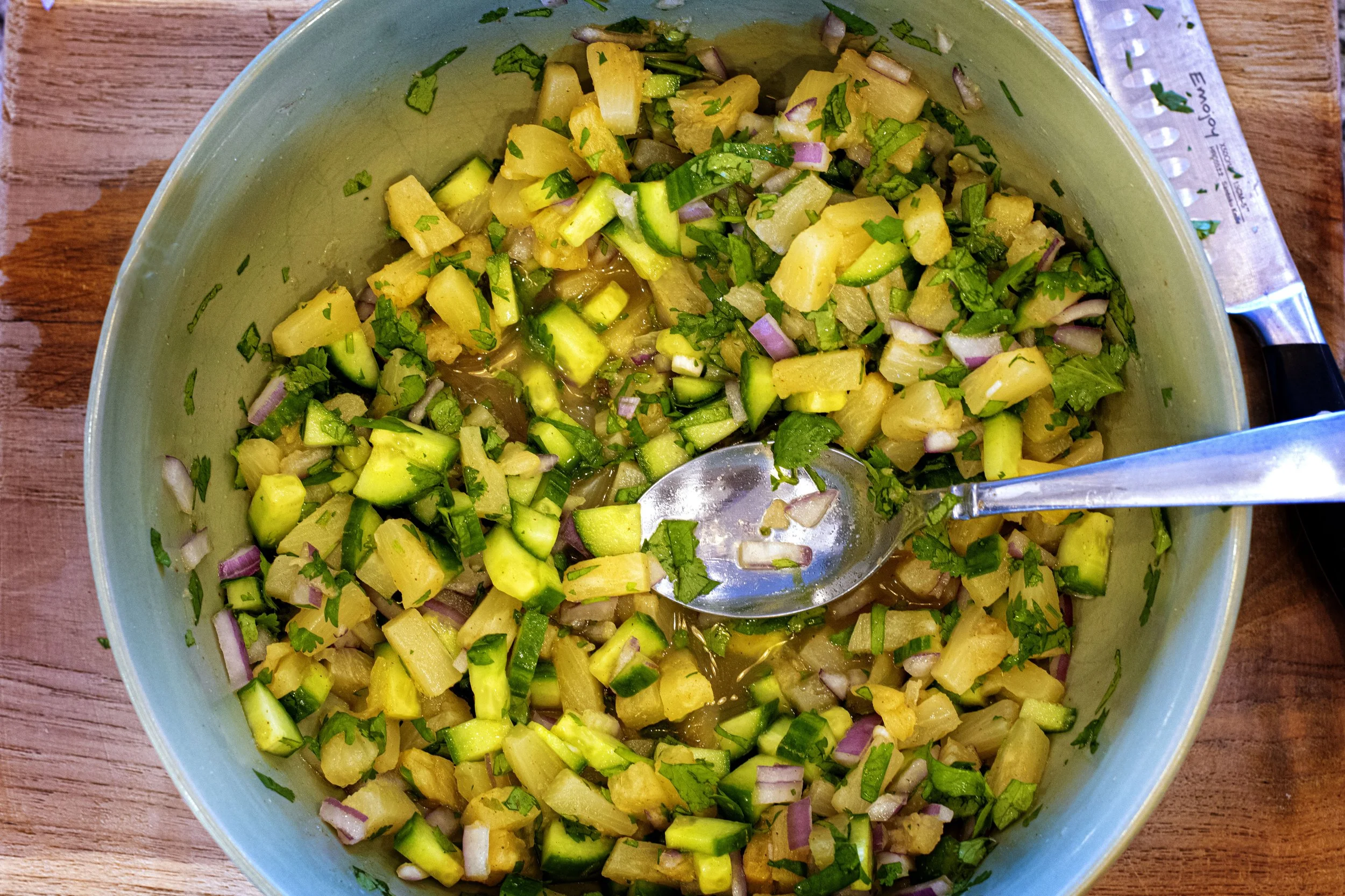 Bowl of fresh, crunchy, sweet pineapple salsa with cucumber, red onion, and cilantro.
