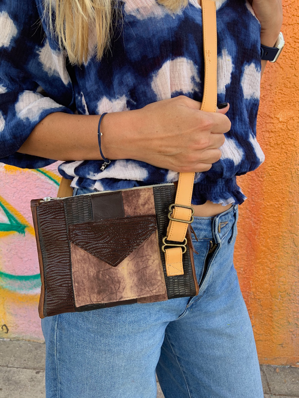 Linn with brown patchwork purse.png