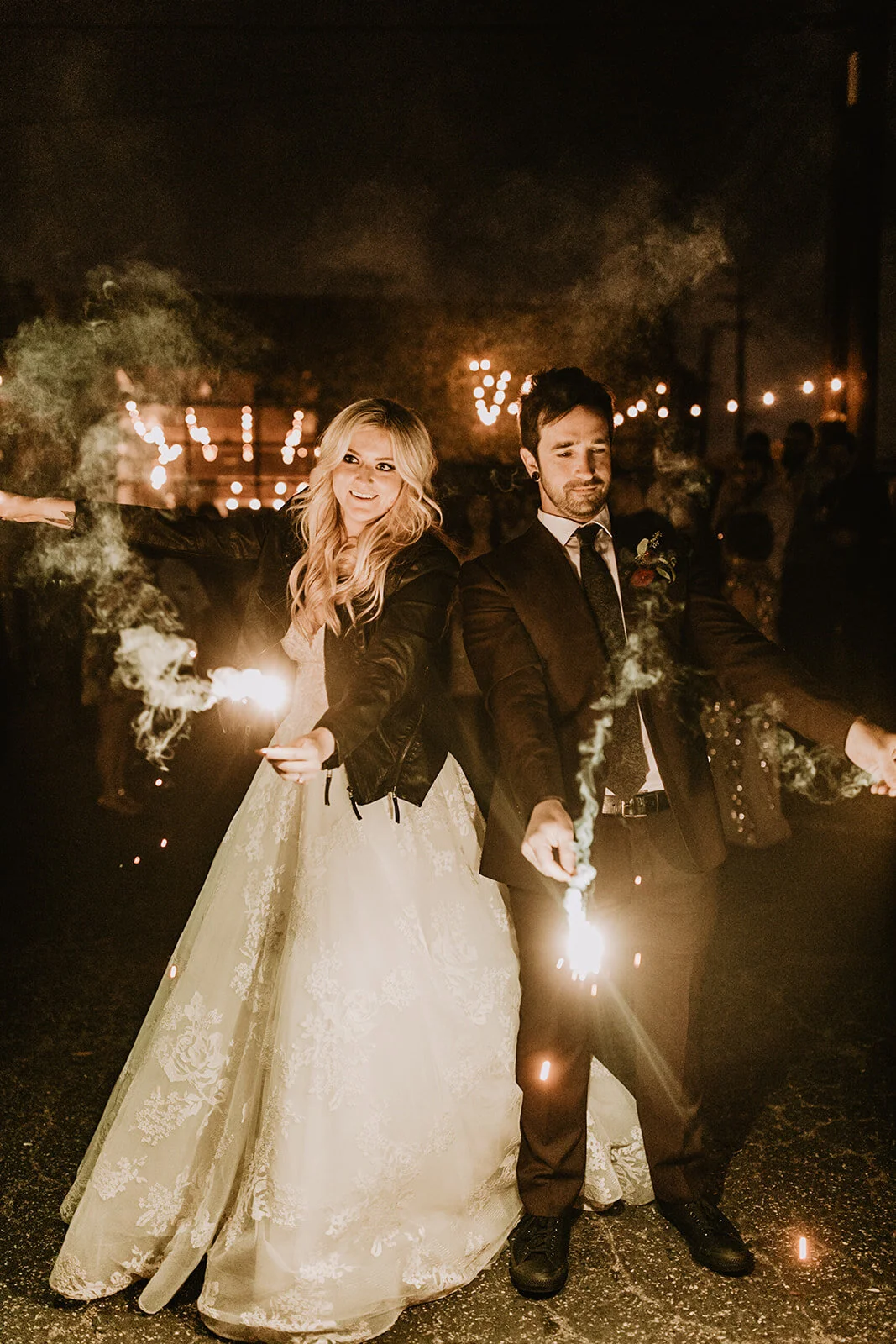 Rock and roll alternative moody Bride and Groom with sparklers in leather jackets