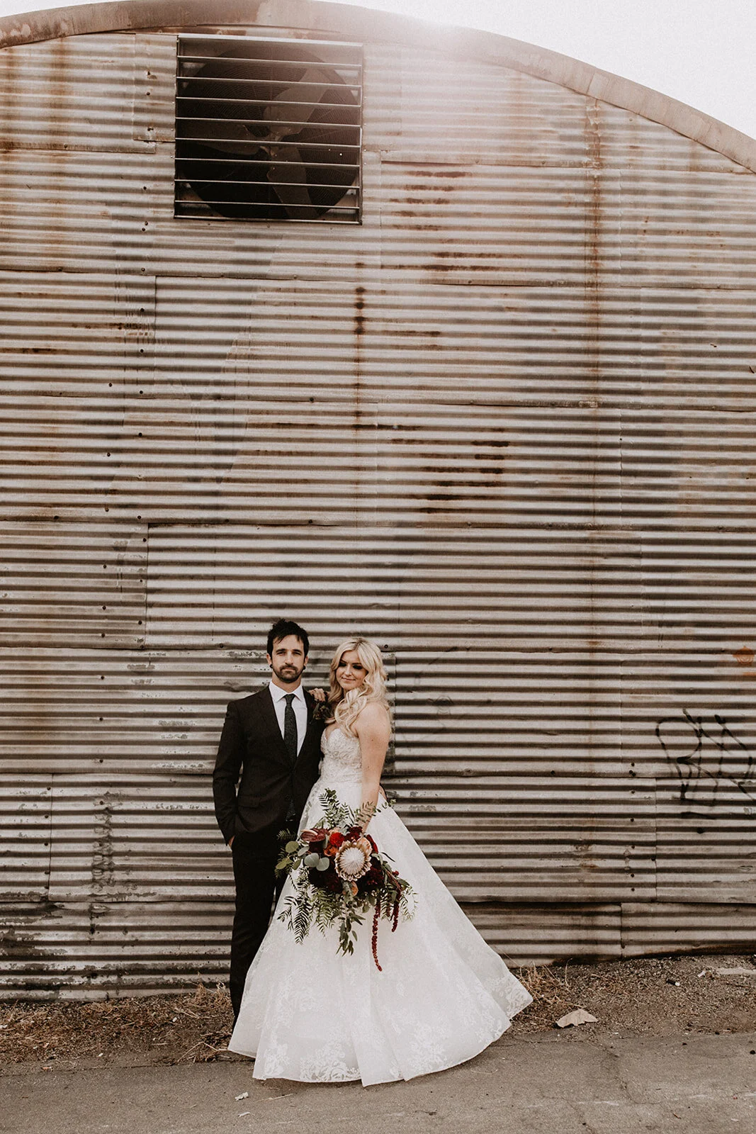 Bride and Groom with moody bouquet flowers at industrial Smoky Hollow Studios in Los Angeles