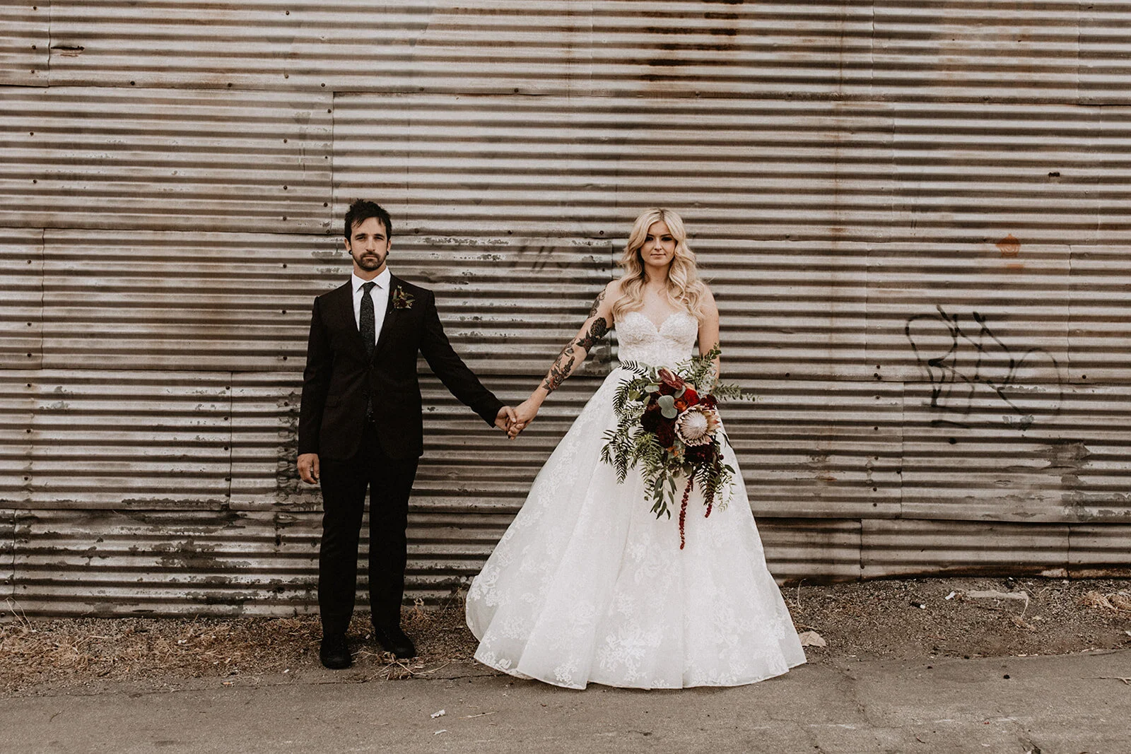 Modern industrial warehouse wedding Bride and Groom in Los Angeles with red flowers