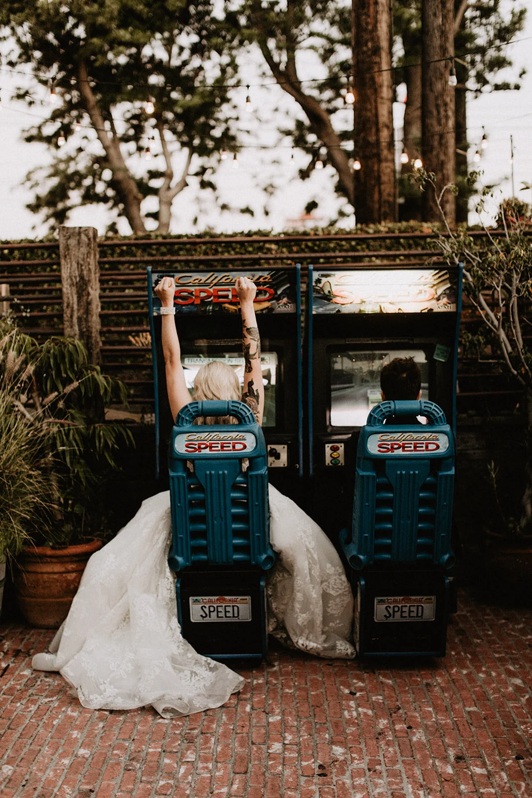 Bride and groom playing arcade games at Los Angeles outdoor indoor wedding