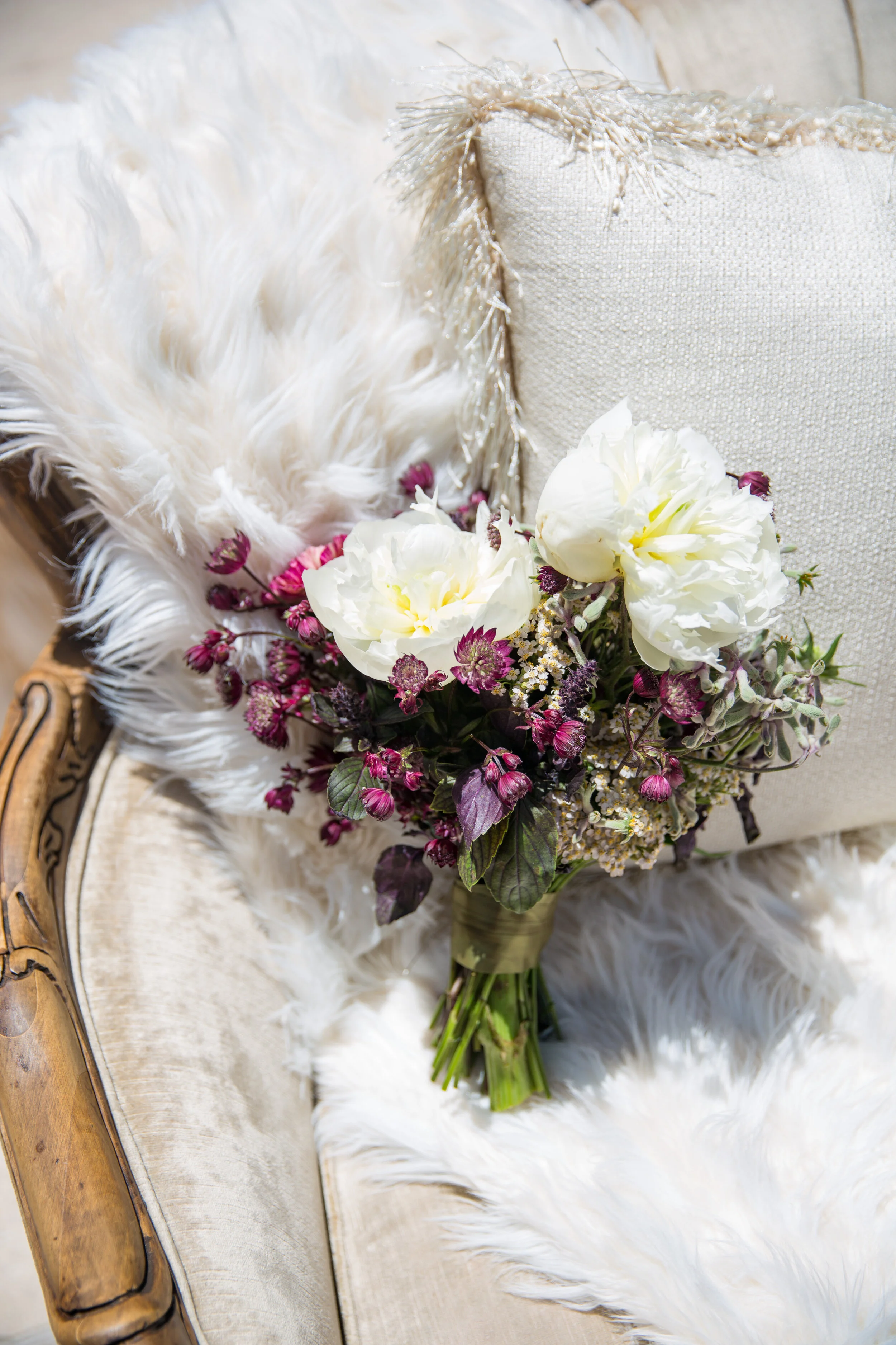  White Peonies are used again here in this petit bouquet but contrasted with a deep purple that gives the bouquet a sense of royalty. I love the purple artichoke too!  Photography by Janet Wheeland 