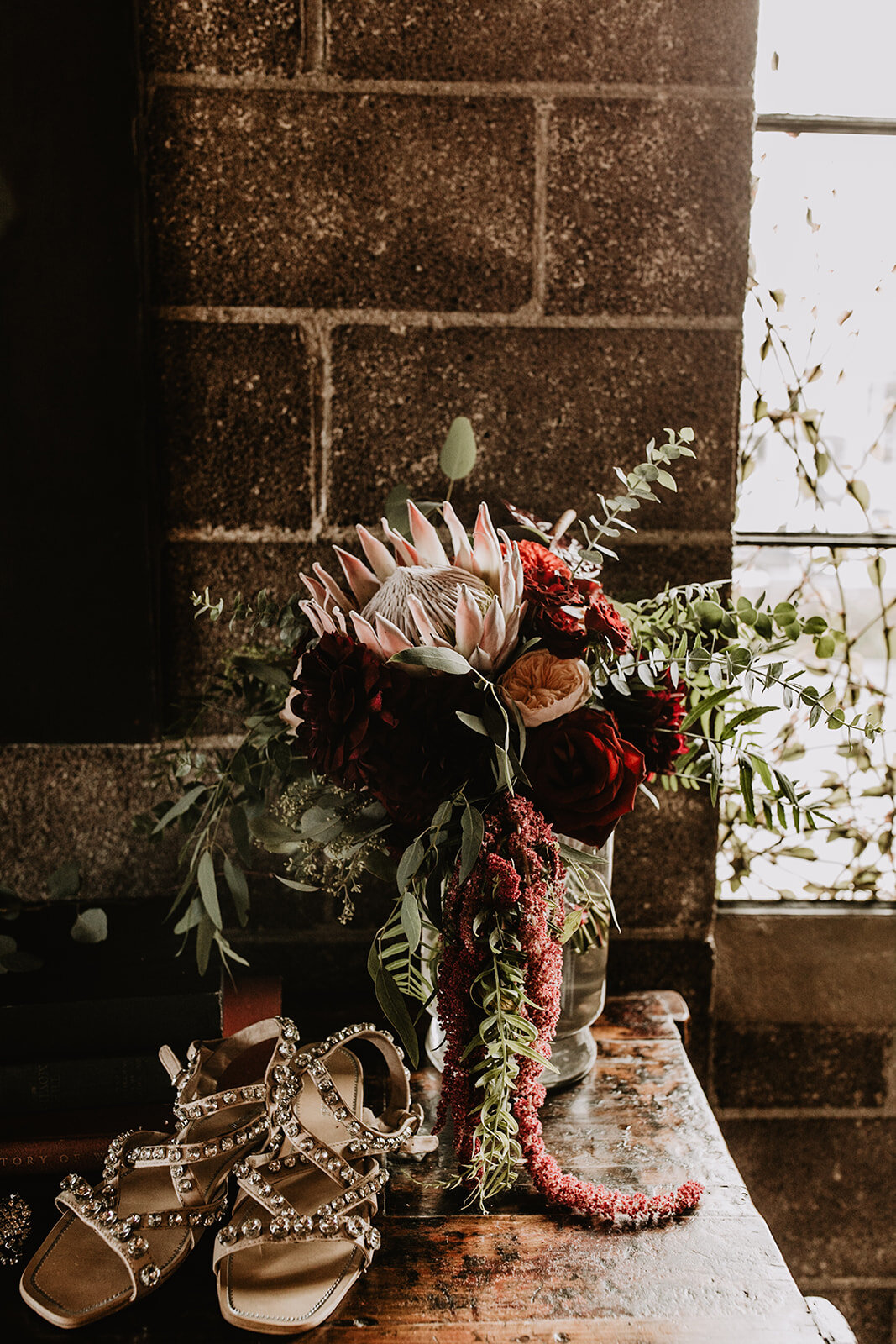  The pink King Protea is everything for this moody boho bouquet. The velvety textures and geometric petals create interest and contrast well with the free flowing movement of the Eucalyptus and Amaranthus.  Photography by Matt and Jess 