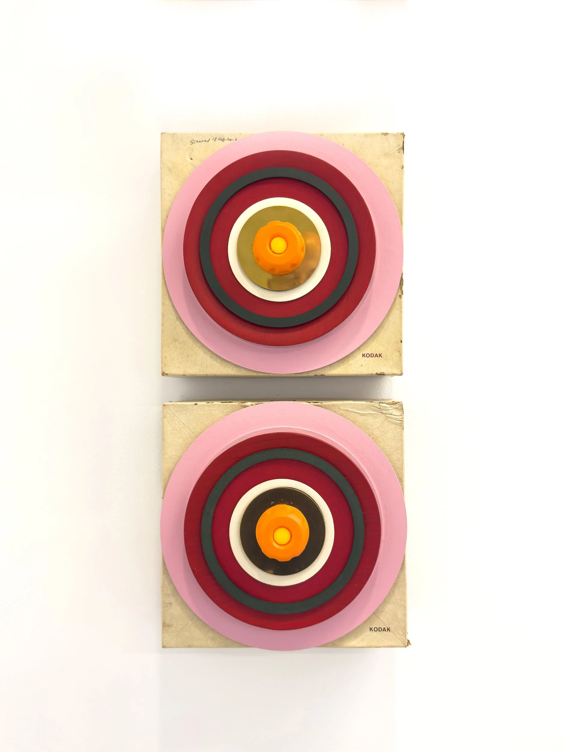 Two square canvases feature concentric circles in pink, red, black, and white, with orange centers. The design evokes a bold, retro feel.