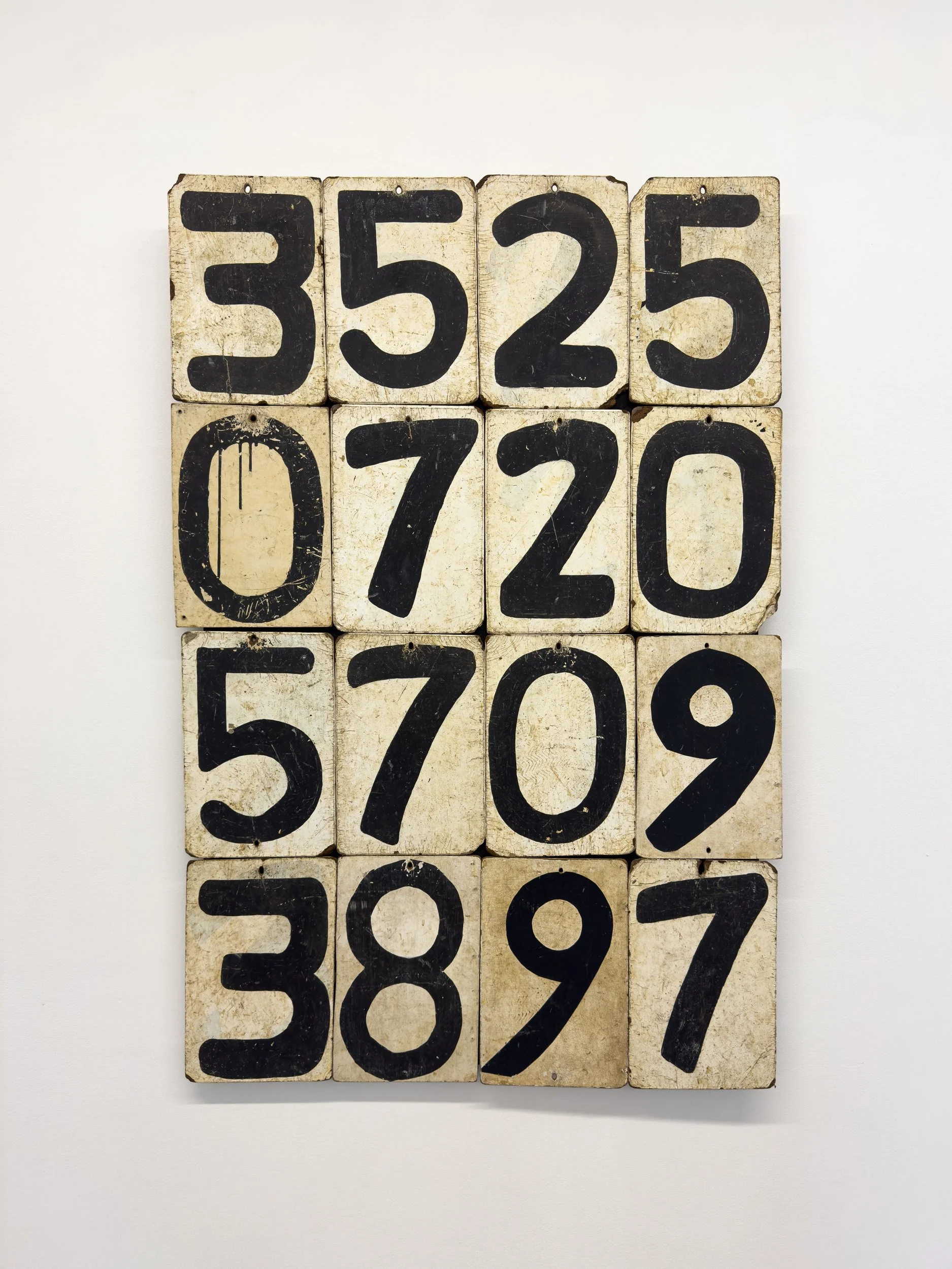 A grid of weathered, vintage wooden tiles displays the numbers 3525, 0720, 5709, and 3897 in bold black on a distressed white background.