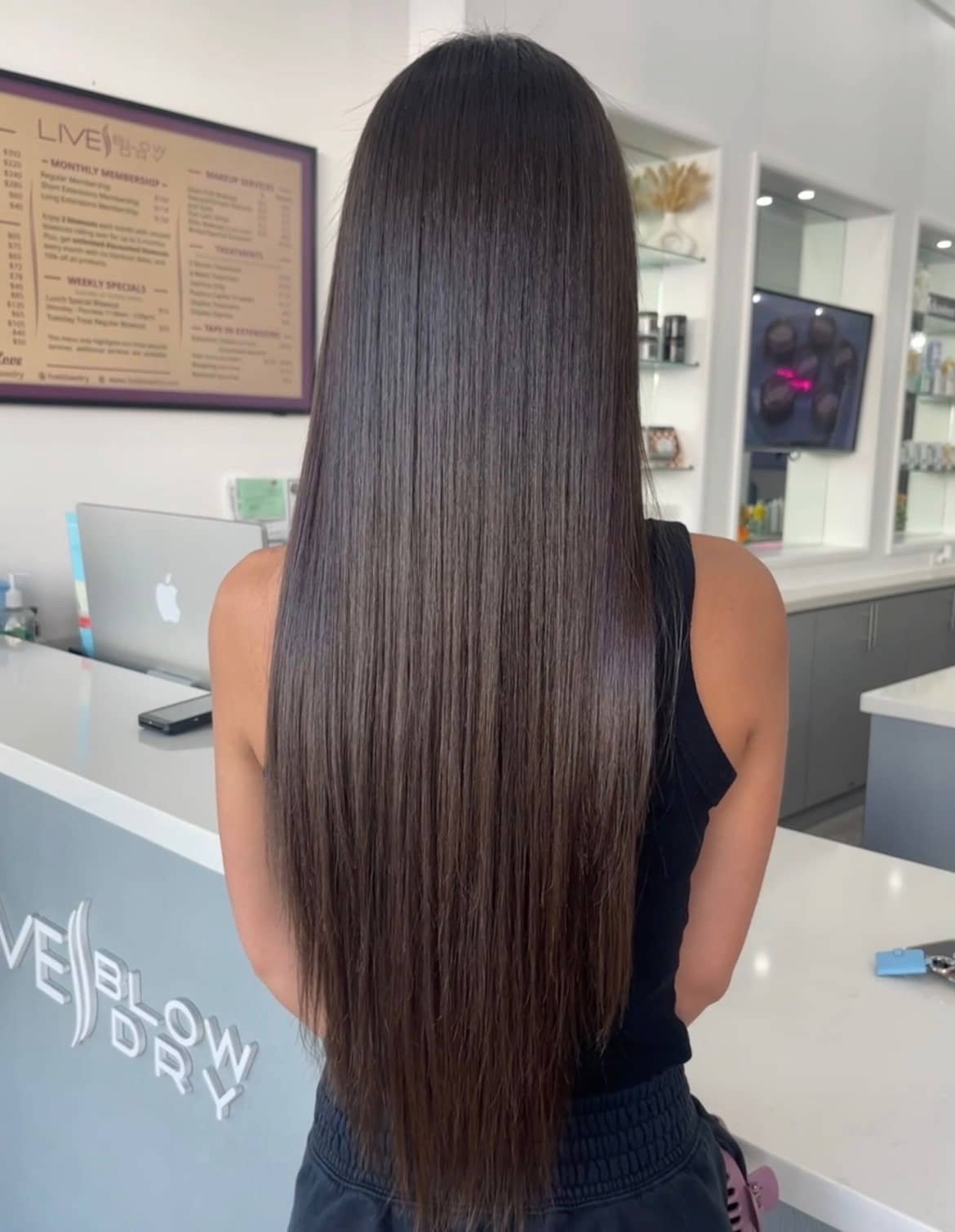 Long straight silky blowout at the Live Blow Dry reception desk in Pinecrest