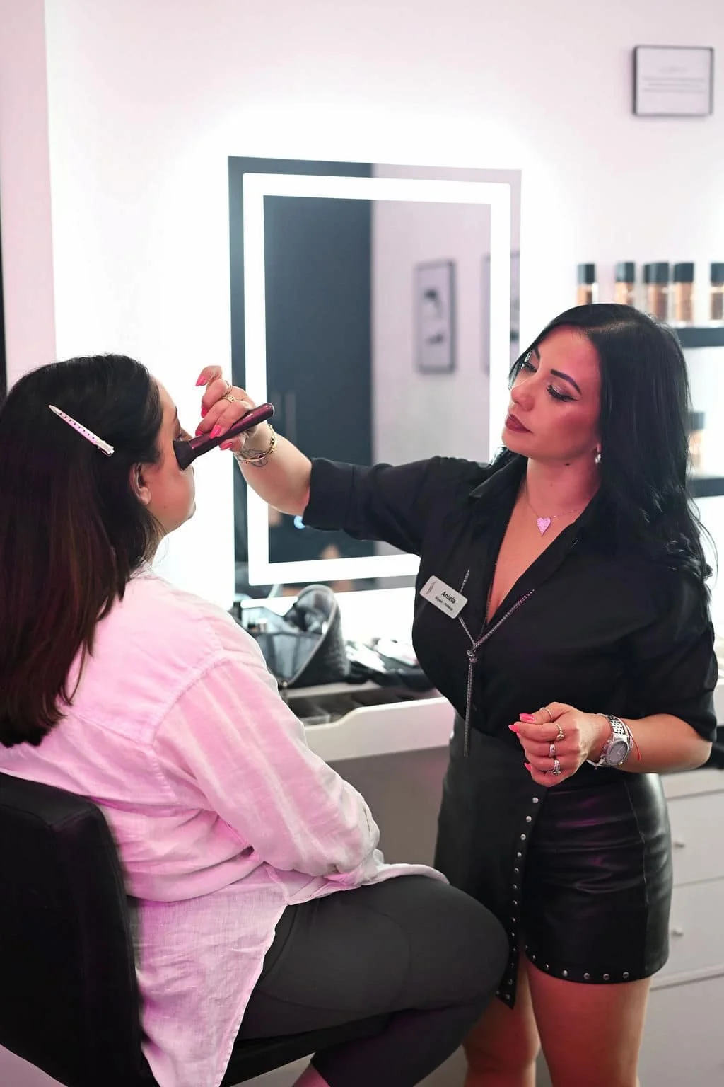 Makeup artist applying makeup to a client at Live Blow Dry in Pinecrest