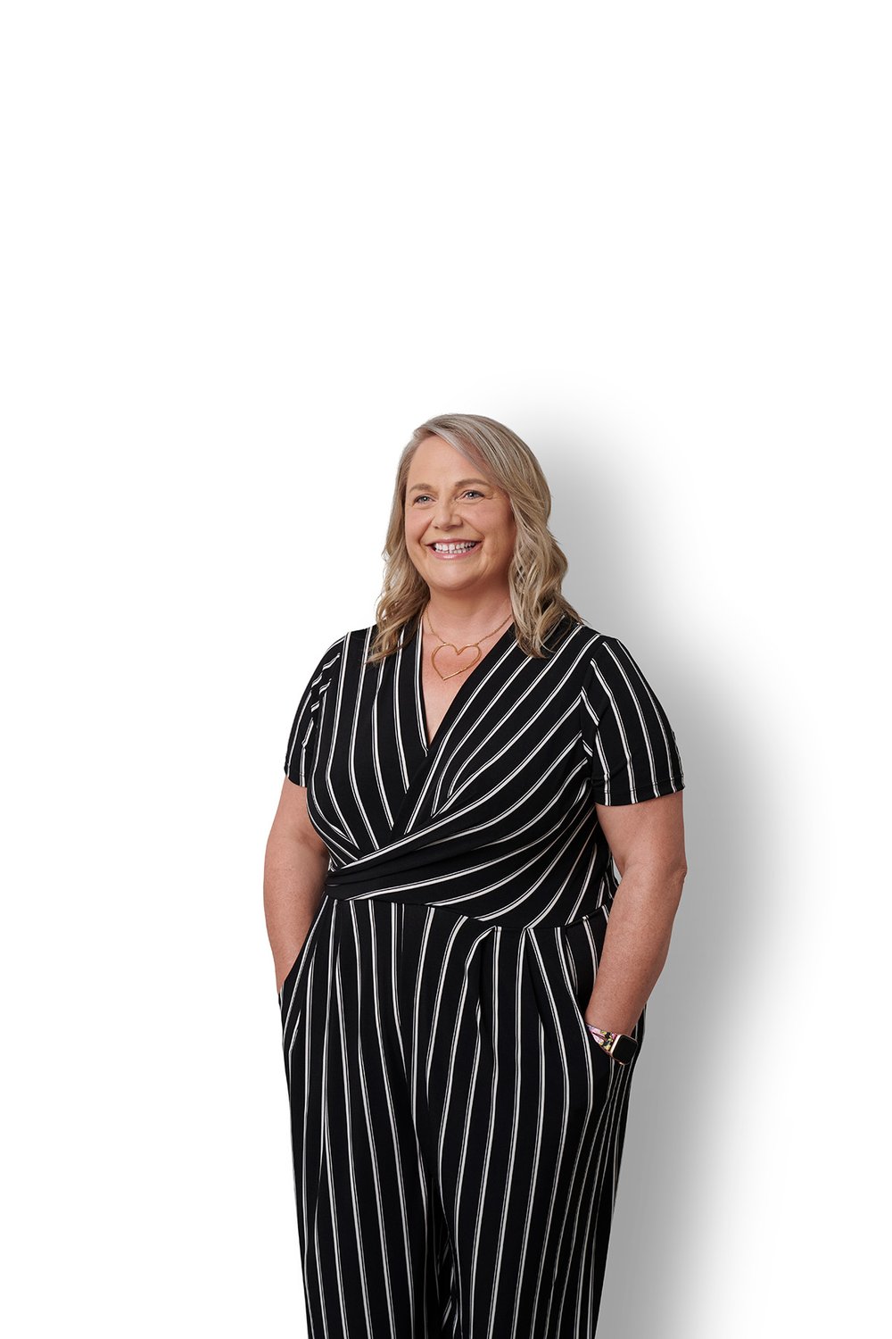 Kendra Holland, interim CEO, connectFirst  Credit Union smiles with hands in her pockets of a black romper.