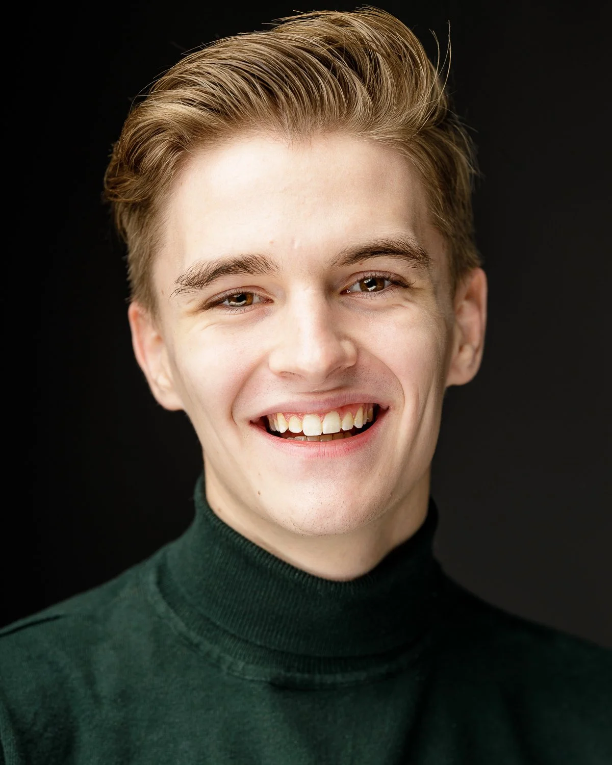 Actors head shot green jumper blond young man