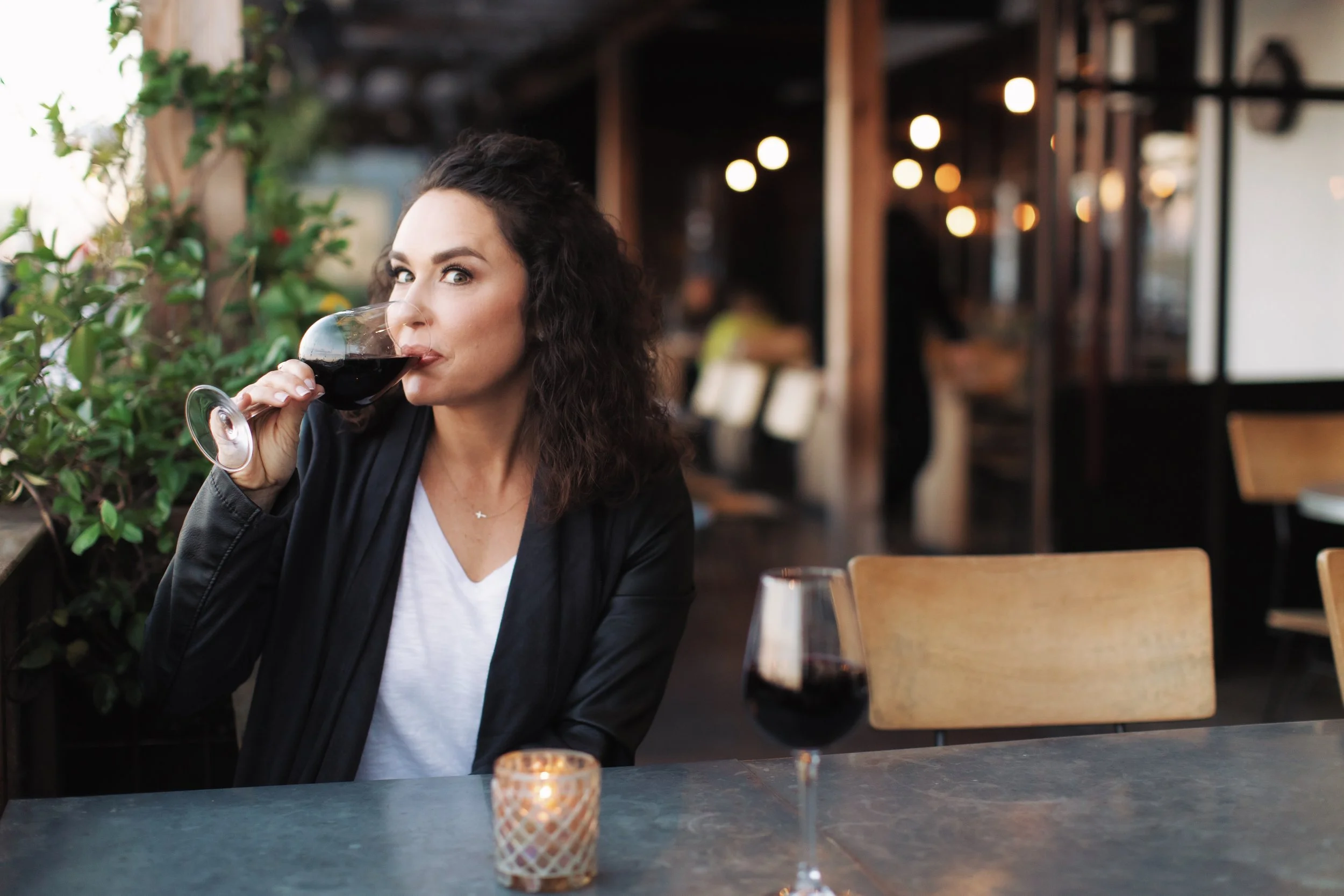 Angela sipping wine in Newport Beach after Covid Cancelled travel plans