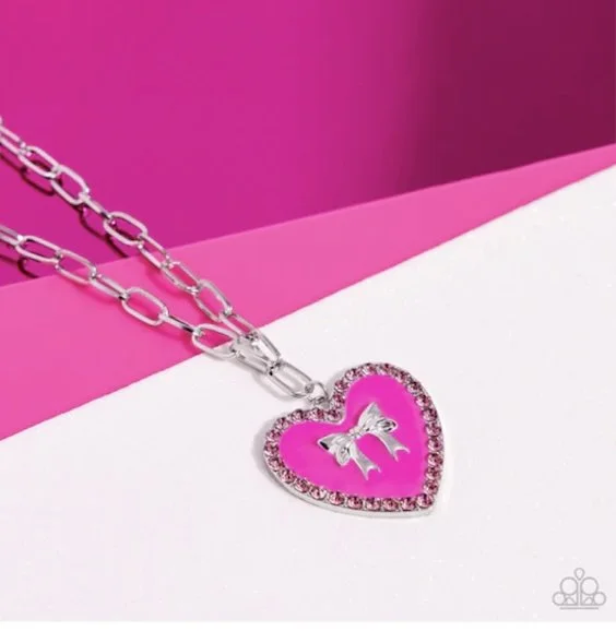 Romantic Gesture-Fuchsia Fedora Pink Heart-Shaped Pendant with Bordered Pink Rhinestones and Center Silver Bow Accent with Matching Silver Colored Chain Earrings