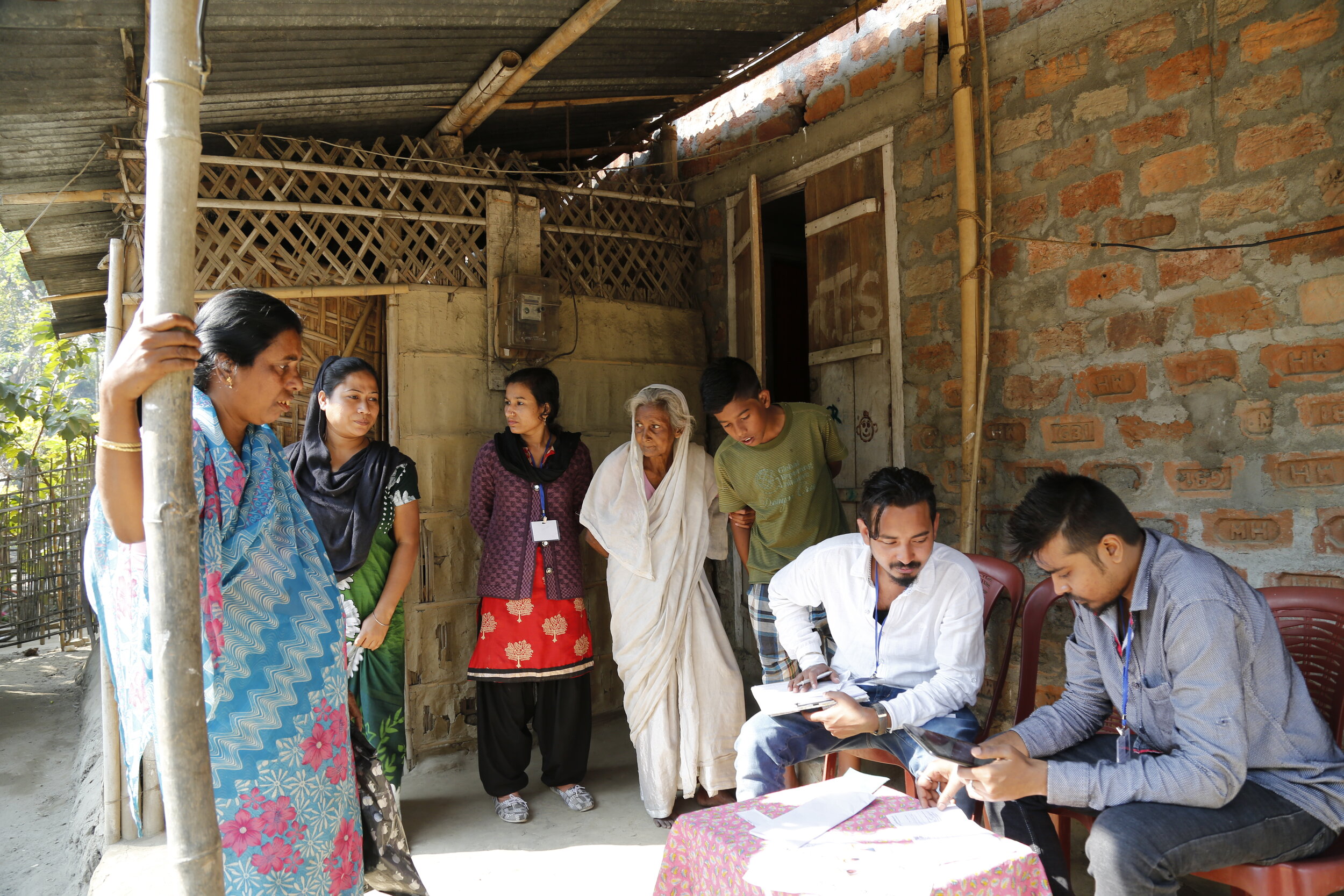  Surveyors filling out the demand survey for a household in door-to-door enumeration exercise