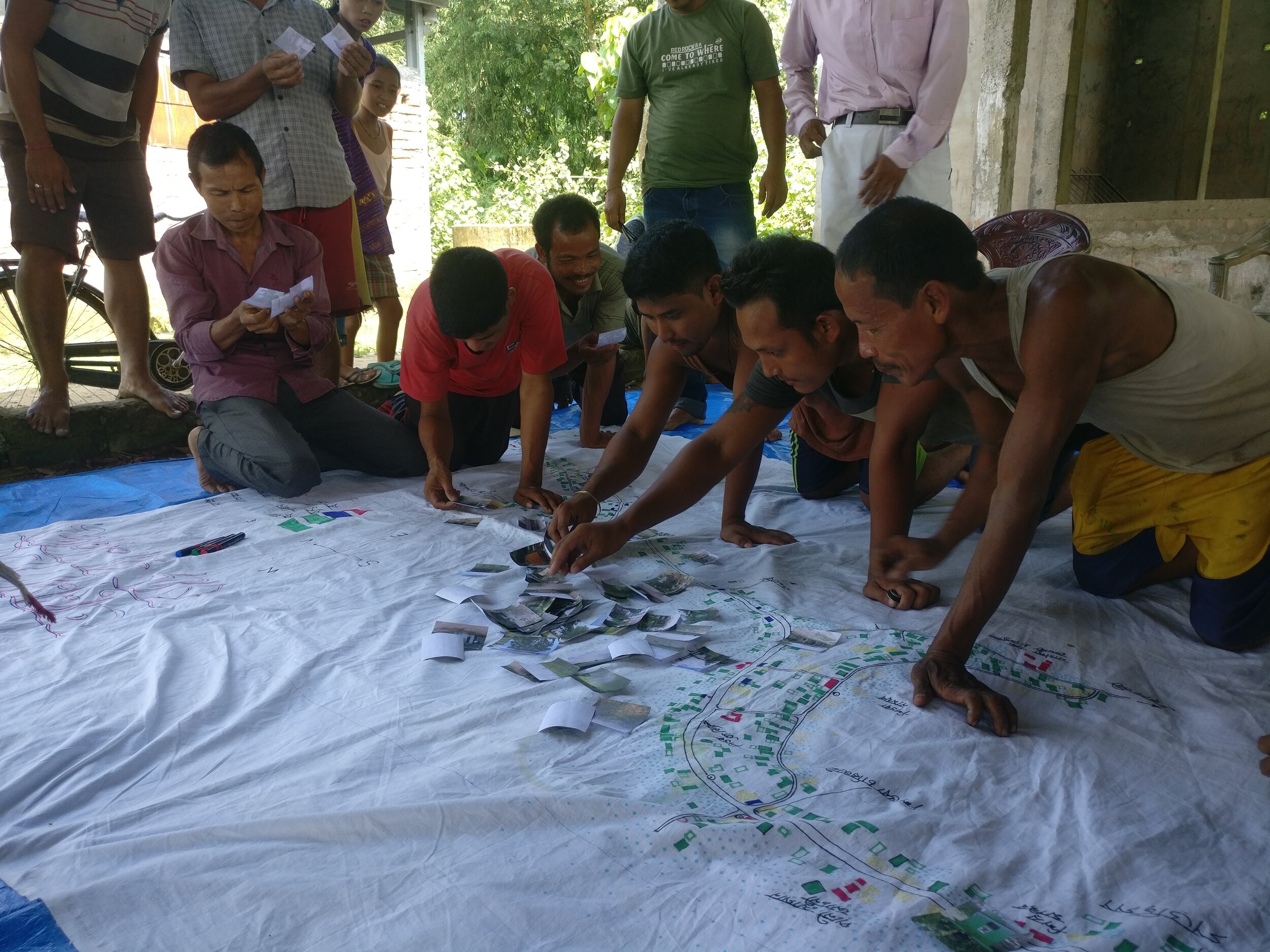 Drishtee Foundation and IHF present the villagers with a large-scale map of their village on which they identify all community and household assets