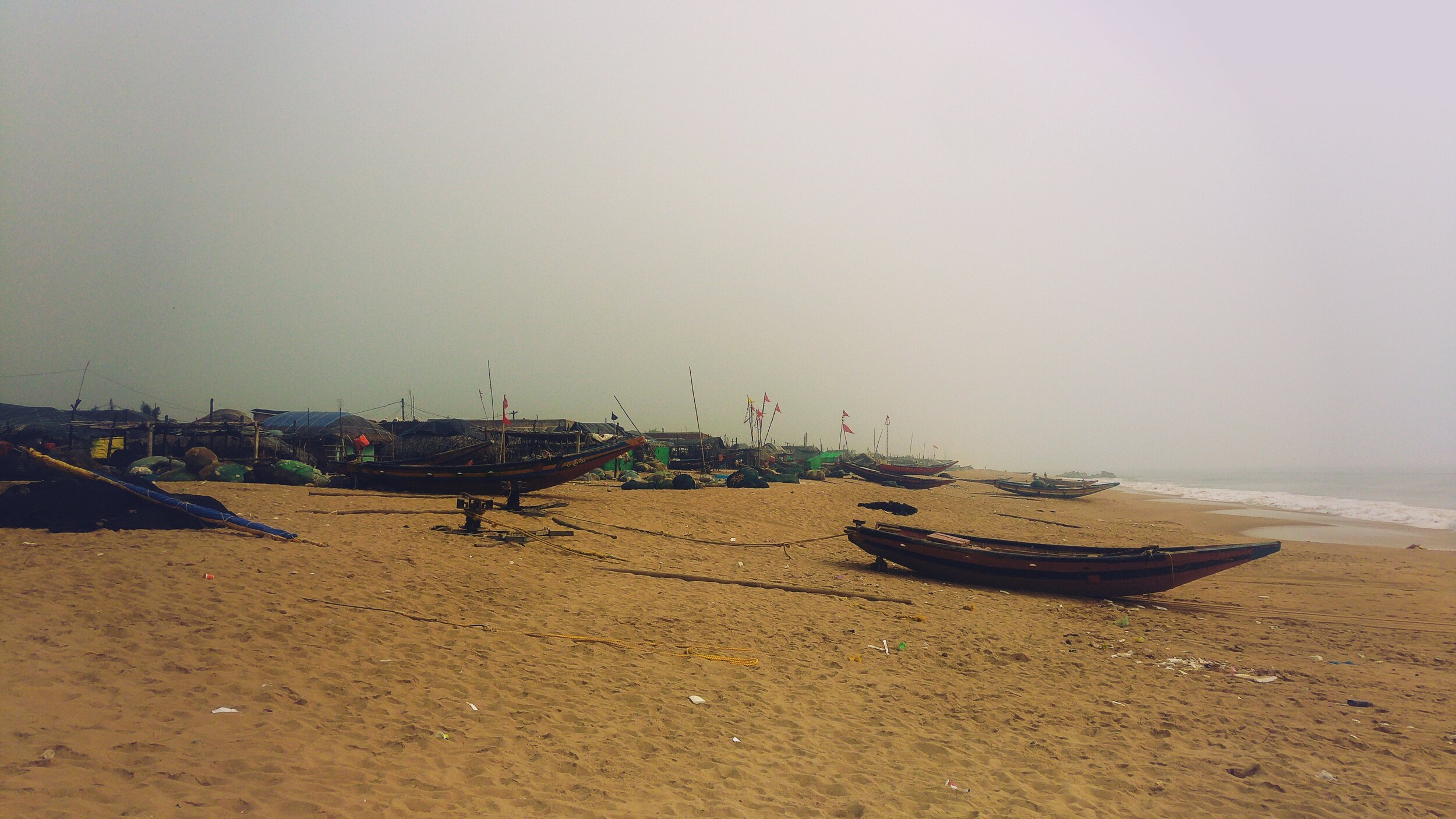 Several boats along the coast next to the settlement indicate the significance of fishing economy