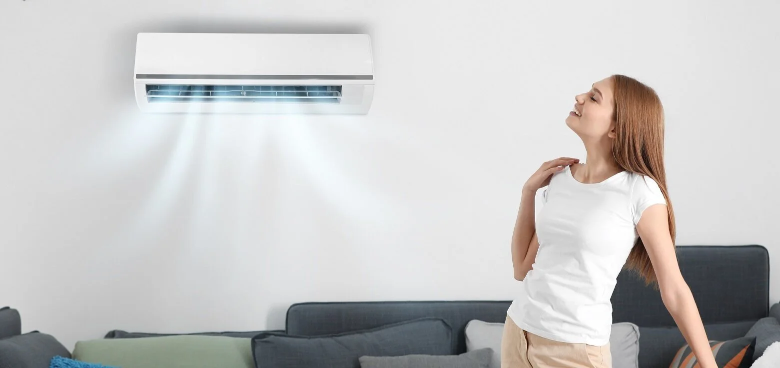 Lady+enjoying+split+system+cooling_AdobeStock_199049030_LR.jpg