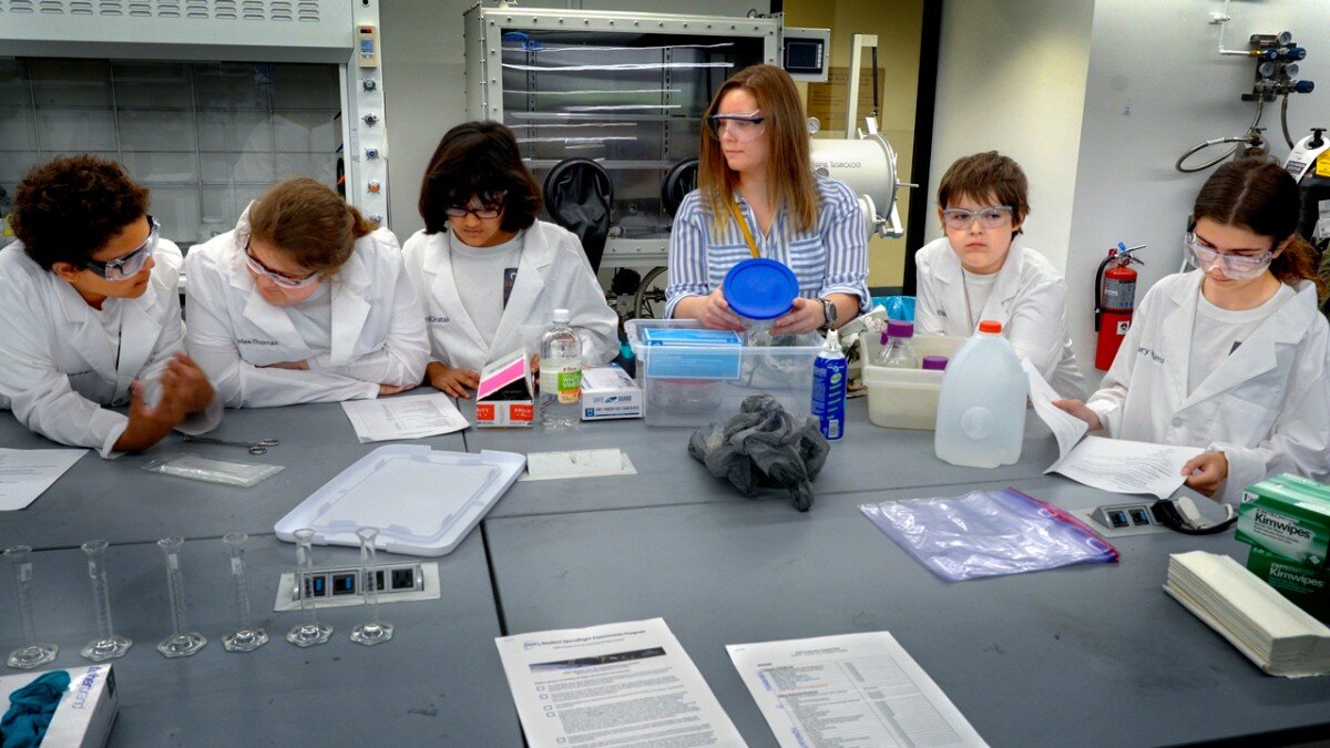 From left, Alex Higginbotham, Skyye Mee-Thomas, Agnika Ghatak, Skyler Rizzo, Jefferson County CCE after-school coordinator, Ryan Arca-Steel and Mallary Williams prepare to assemble their space-bound experiment. (image via John Munson/Cornell University).