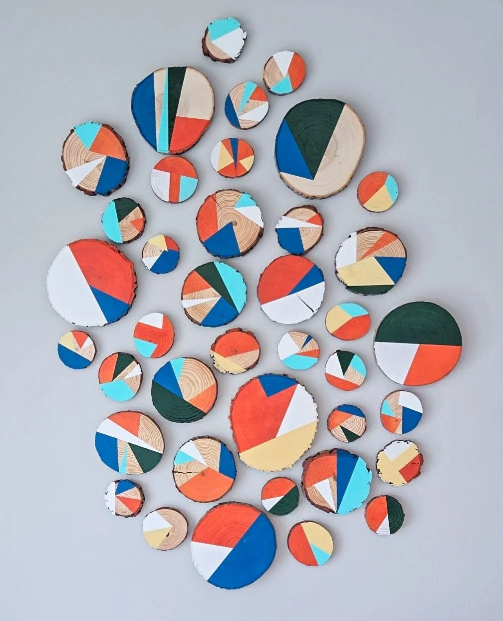 Nature meets artistry&mdash;our hand-painted wood discs at Park Landing reflect the organic character of Woodbridge. This layered installation blends craftsmanship and natural inspiration, bringing a grounded, contemporary feel to the amenity environ