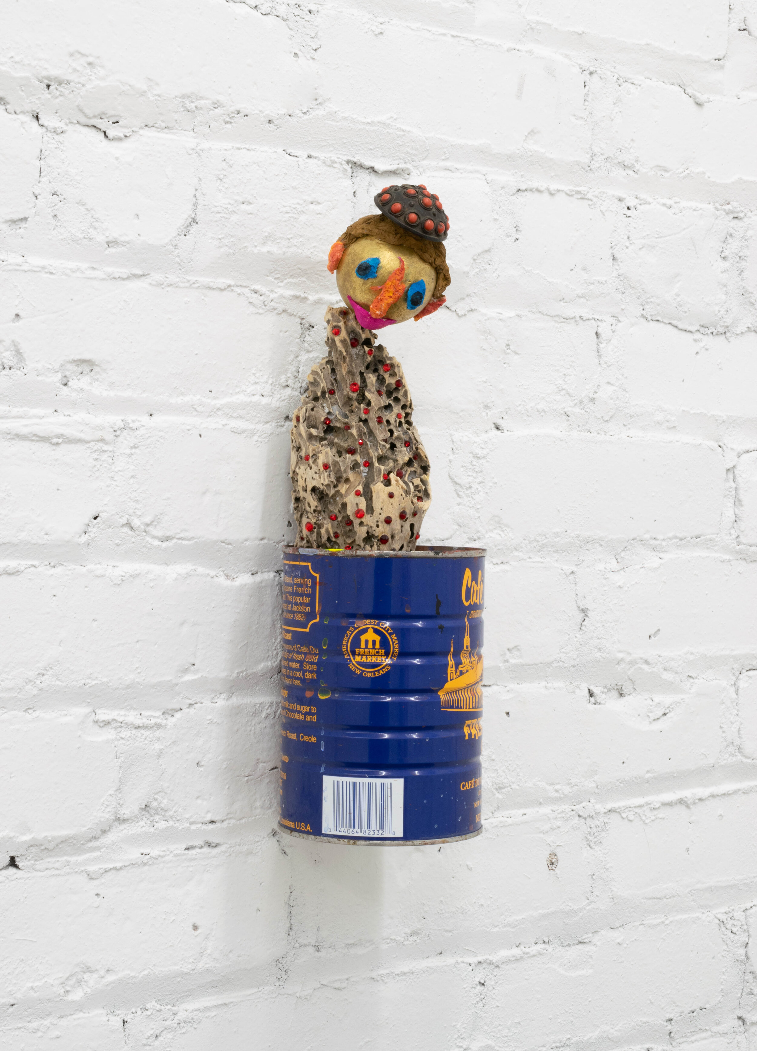 Du Monde, 2019, drift wood, coffee can, swarovski crystals, gold leaf on wood, gouache, toilet paper, 19th century Chinese coral and brass snuff bottle top, 12 x 4 x 4 inches