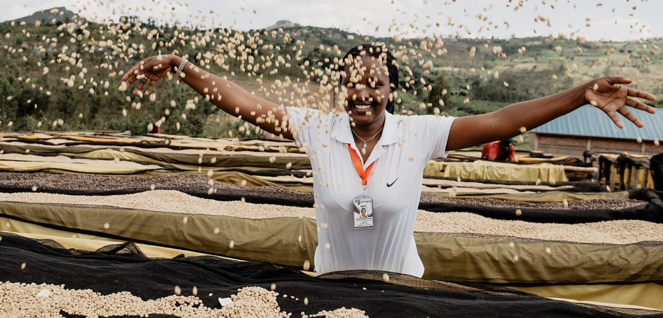 Woman throwing raw coffee in the air