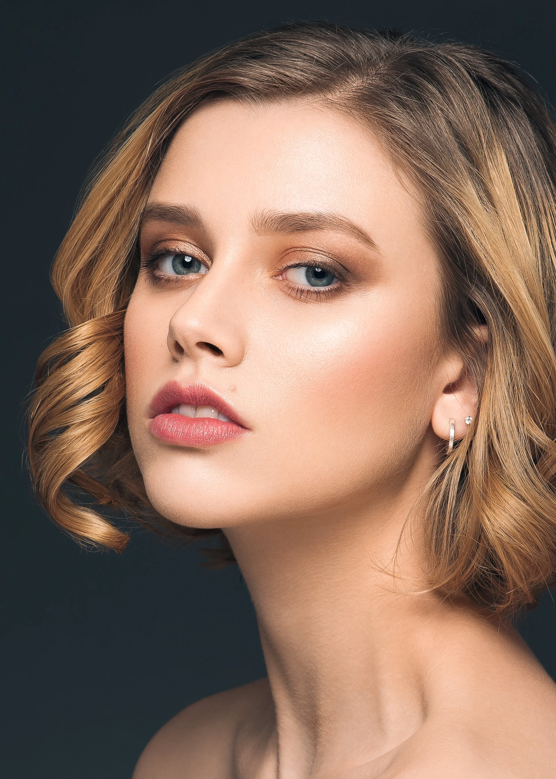 Natural looking curled hair on beauty shot campaign .