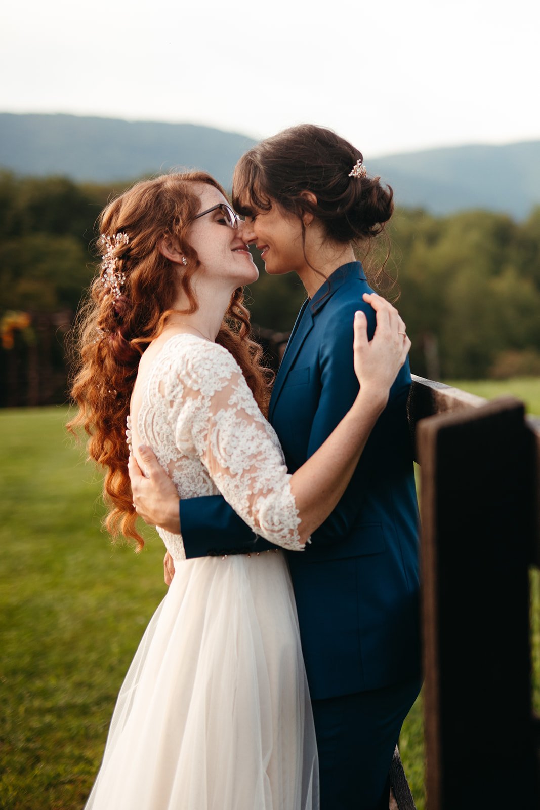 LGBTQ couple in souther Virginia for their wedding portraits. One bride has natural curls and the other a low updo