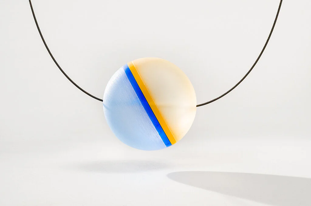 Haze Reflector Pendant 1, 2016 Carved acrylic, brass, guitar string Image by Grace Laemmler