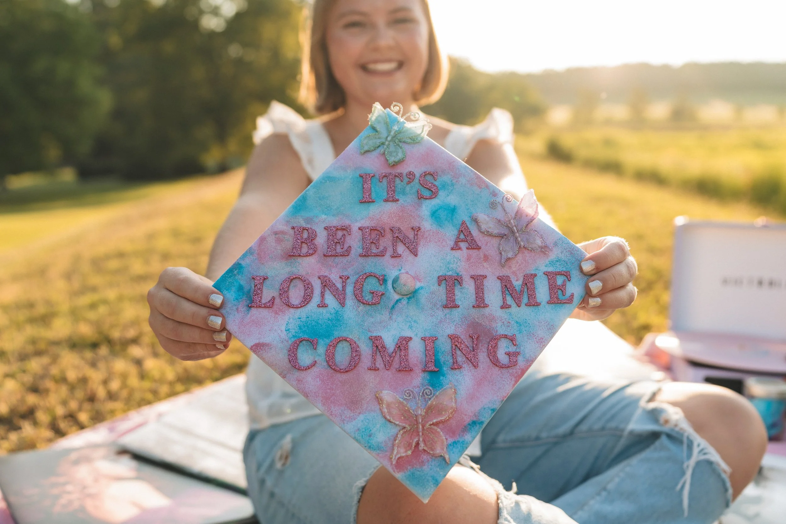 Cute song lyrics grad cap quote "It's been a long time coming" 