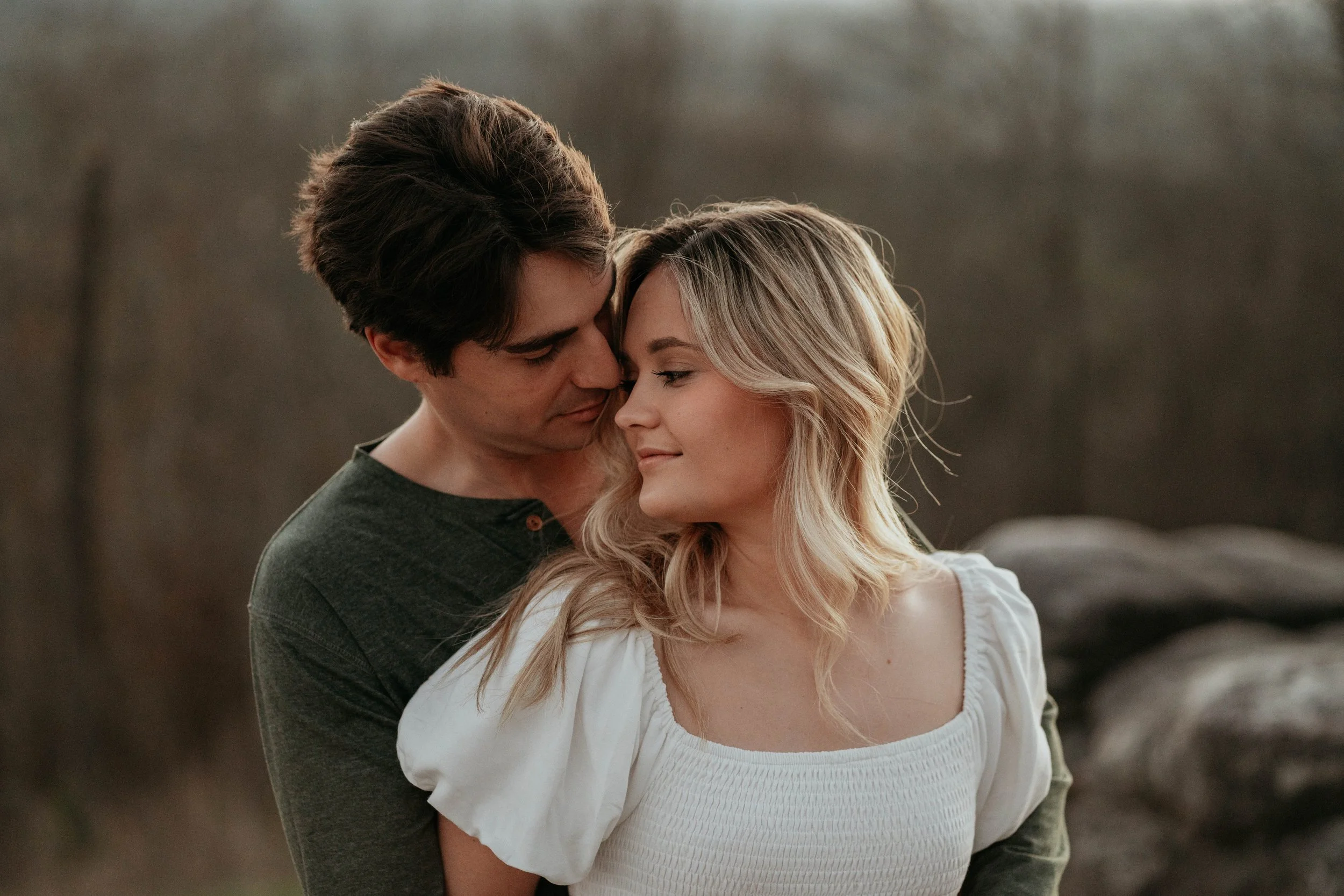 Pine Mountain, GA couple sharing an intimate moment outdoors, intimate elopement photoshoot on mountain trail overlook in state park