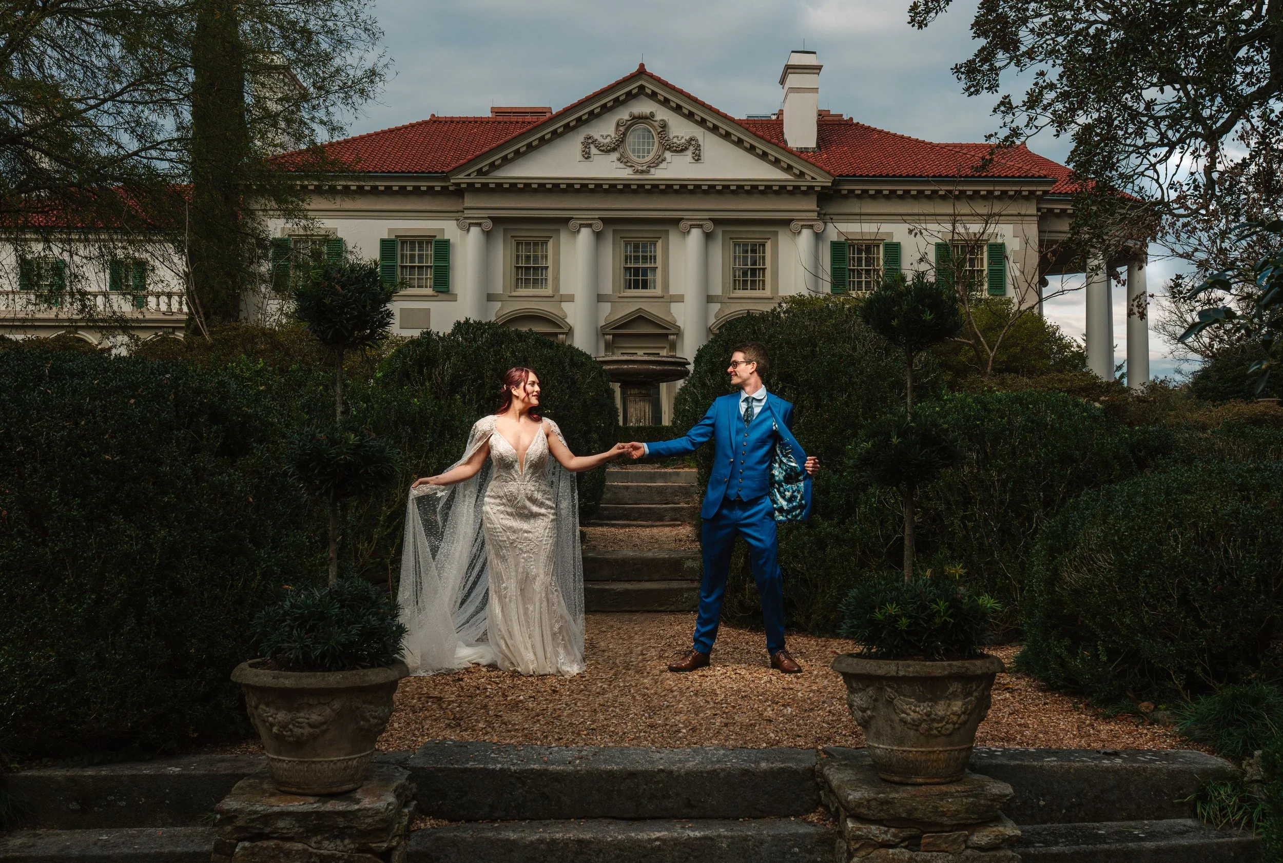 Historic mansion wedding photo, Hills and Dales Estate with couple in front of manor in the garden, moody fall outdoor wedding